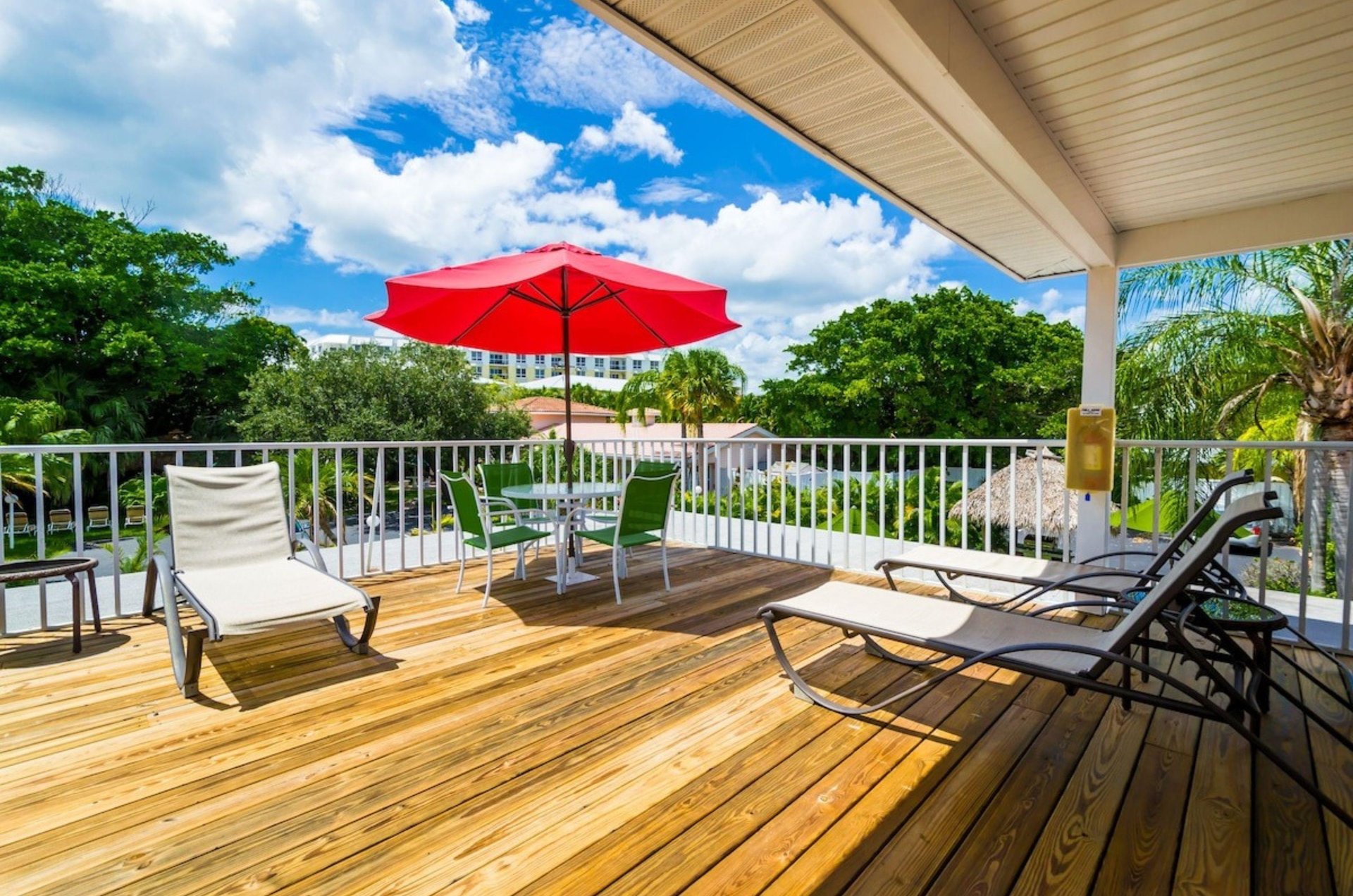 An outdoor sundeck with lounge chairs and tables at Tropical Beach Resorts in Siesta Key Florida