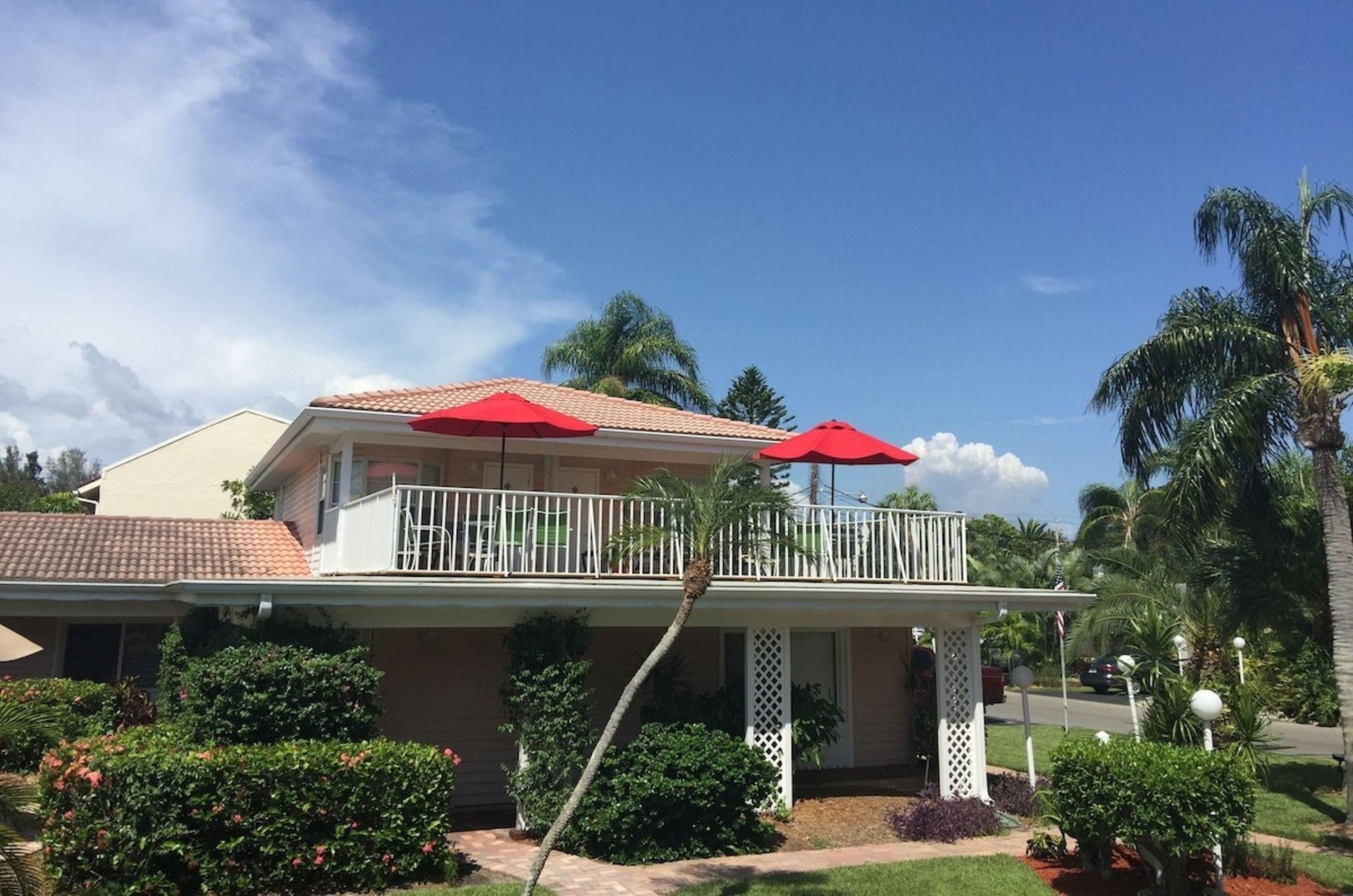 View from the street of a second story outdoor terrace at Tropical Beach Resorts in Siesta Key Florida