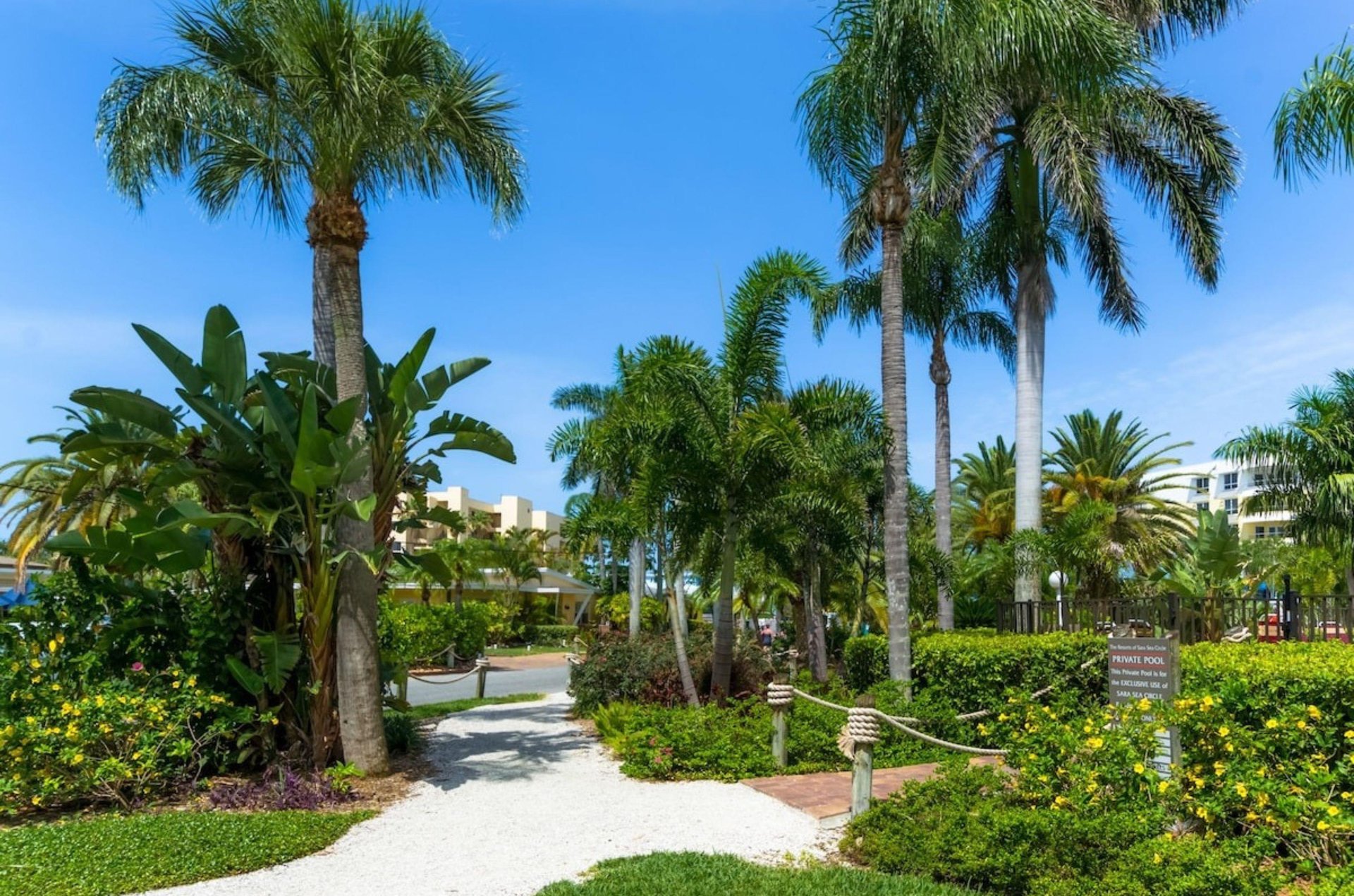 Lush gardens and a walkway on the grounds of Tropical Beach Resorts in Siesta Key Florida
