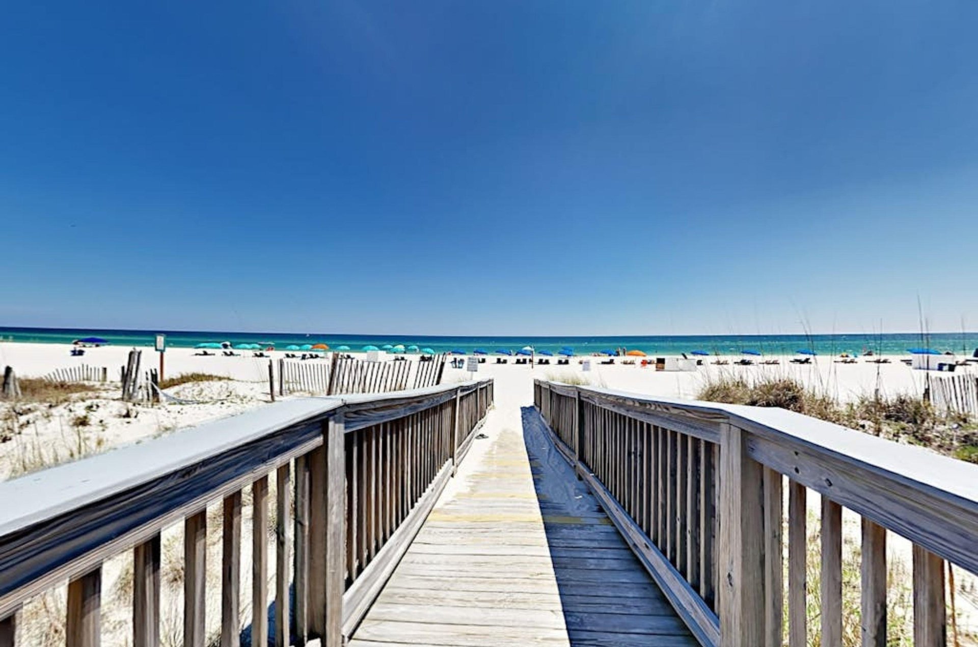 A wooden boardwalk going towards the beach at Island Tower in Gulf Shores Alabama