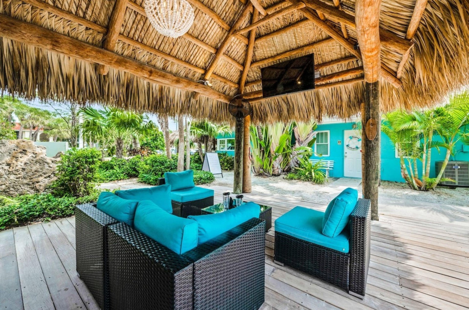 The covered outdoor patio with lounge chairs and a television at Tropical Breeze Resort in Siesta Key Florida