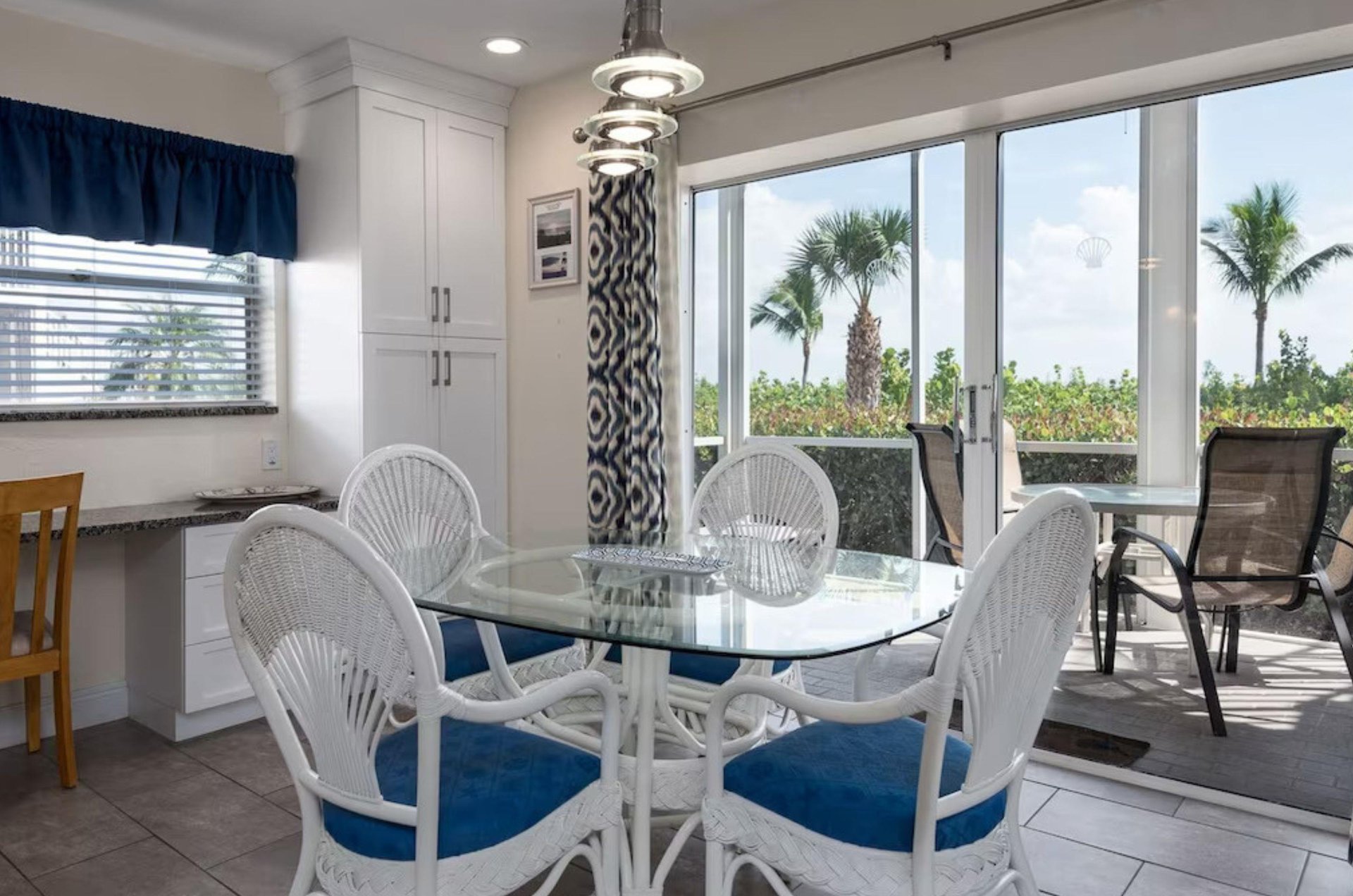 The dining room and private balcony of a beachfacing condo