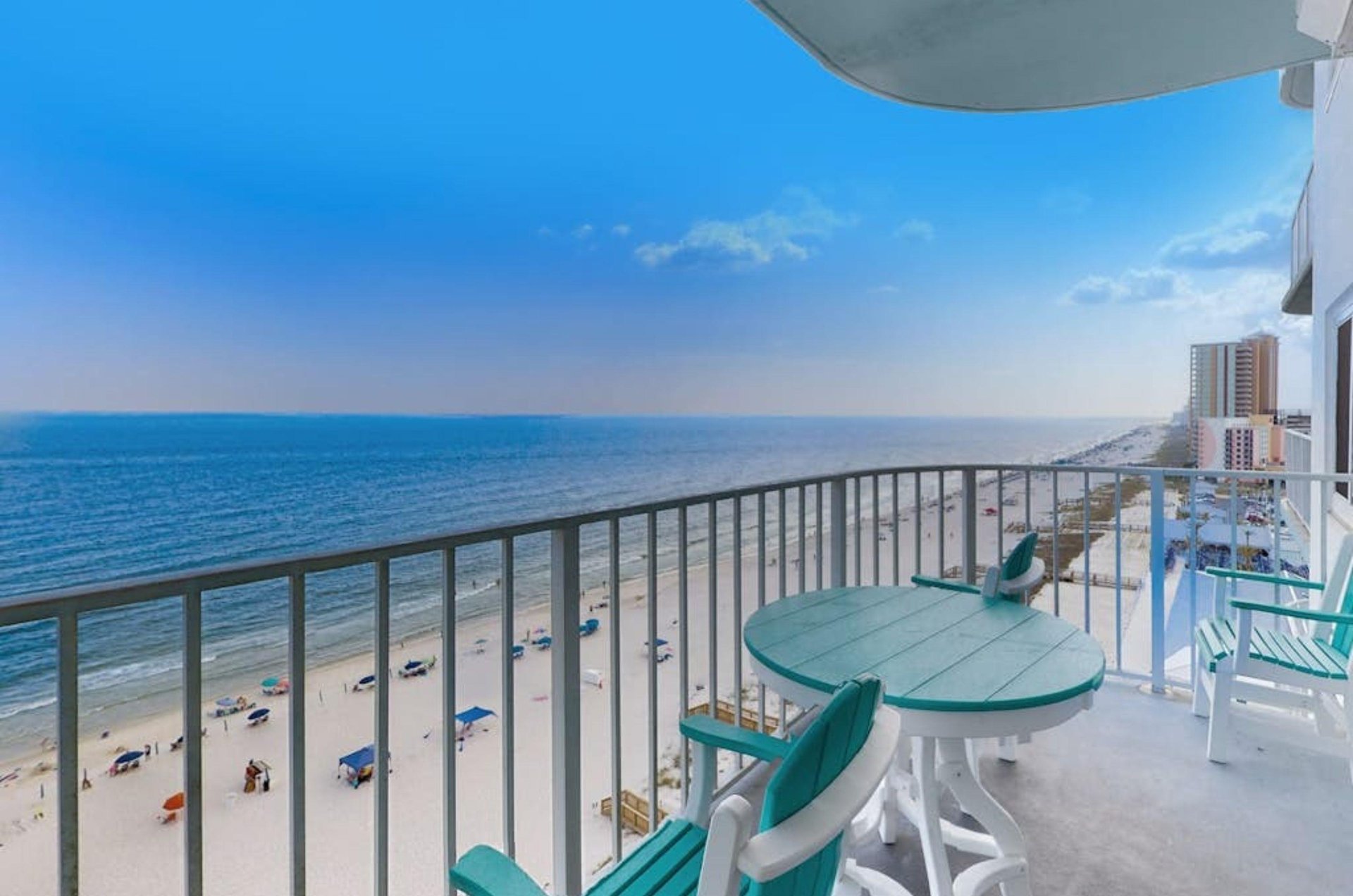 A balcony with a table and chairs overlooking the Gulf at Summerchase Condominiums