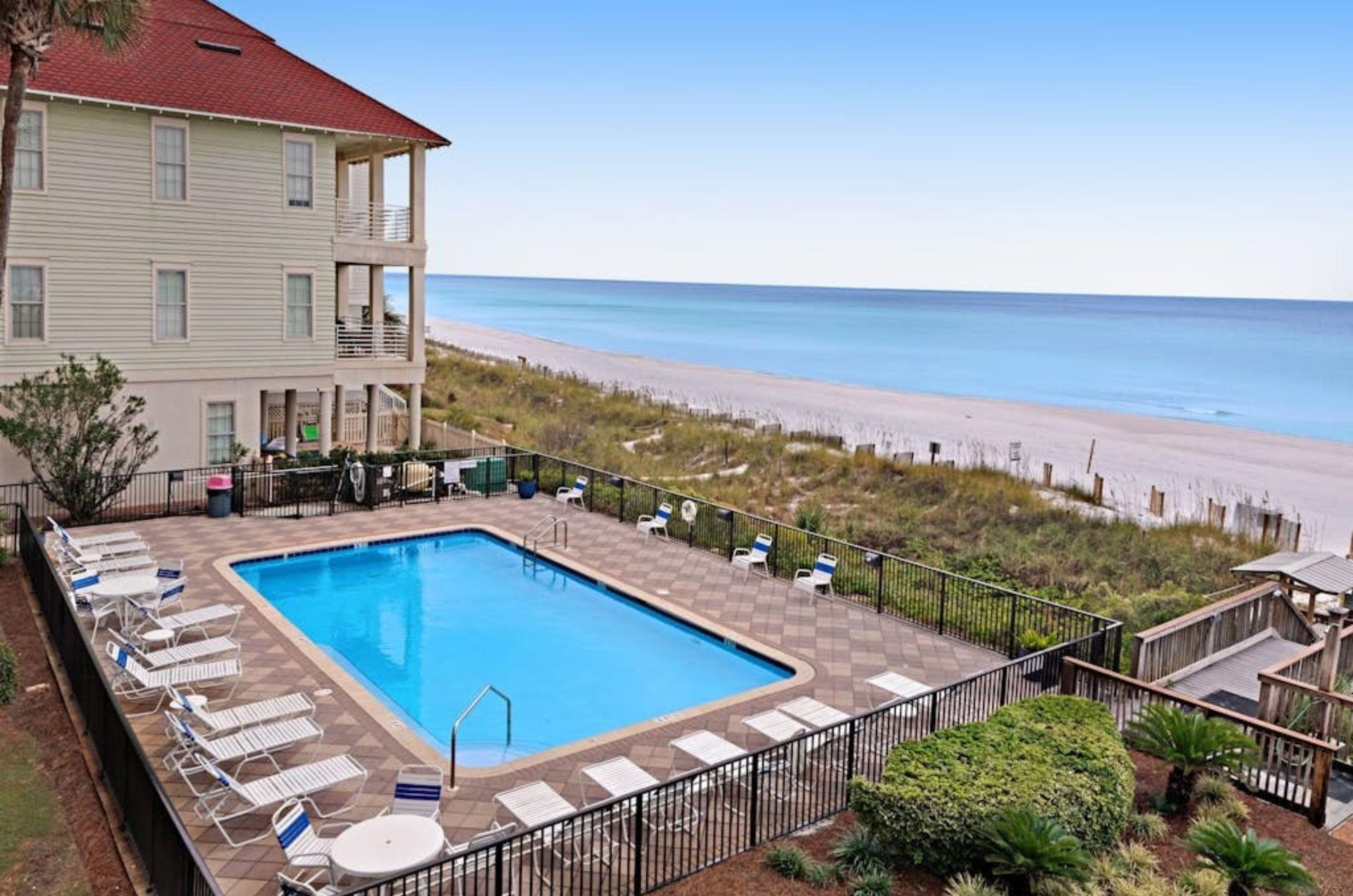 A balcony view of Huntington by the Seas beachside swimming pool spacious sundeck and boardwalk to the beach