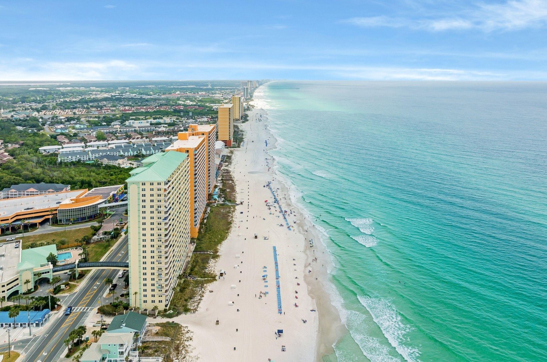 Aerial view looking down the coast with Splash Resort next to the beach