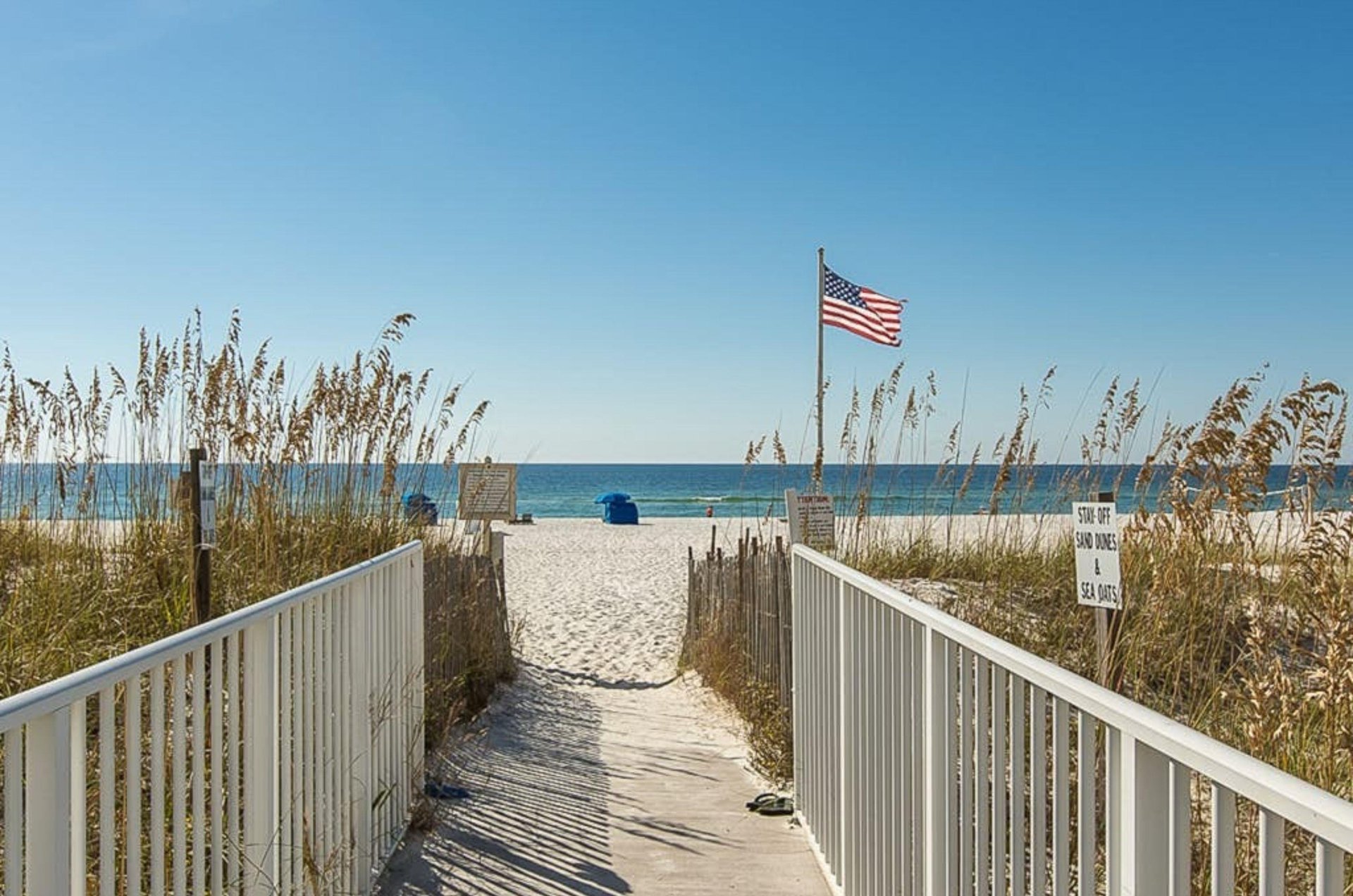 A wooden boardwalk leading to the beach at Sugar Beach