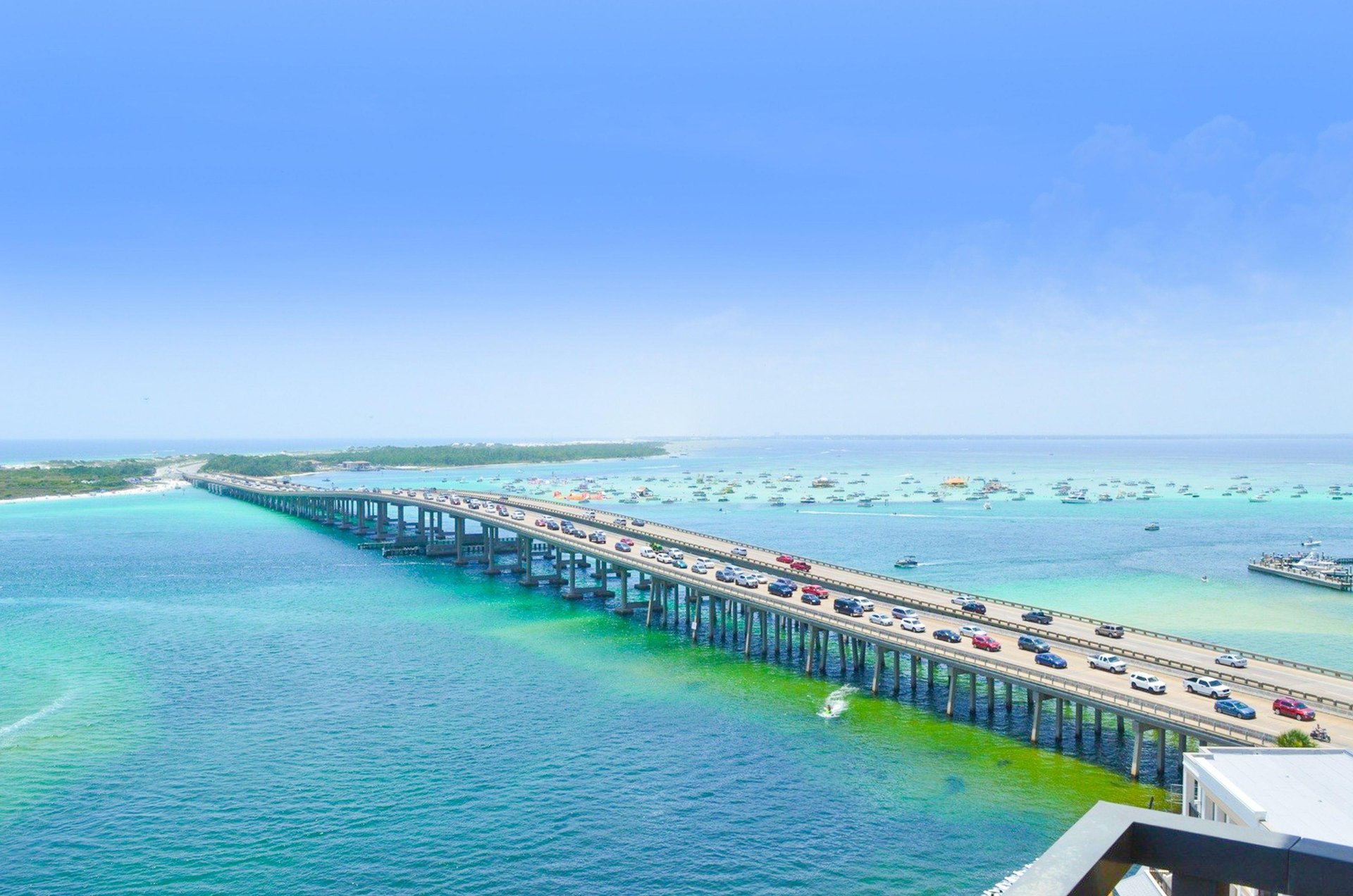 Destin Pass, the Destin Bridge and boats gathered to party on Crab Island beyond are part of beautiful scenery guests can see from Emerald Grande.