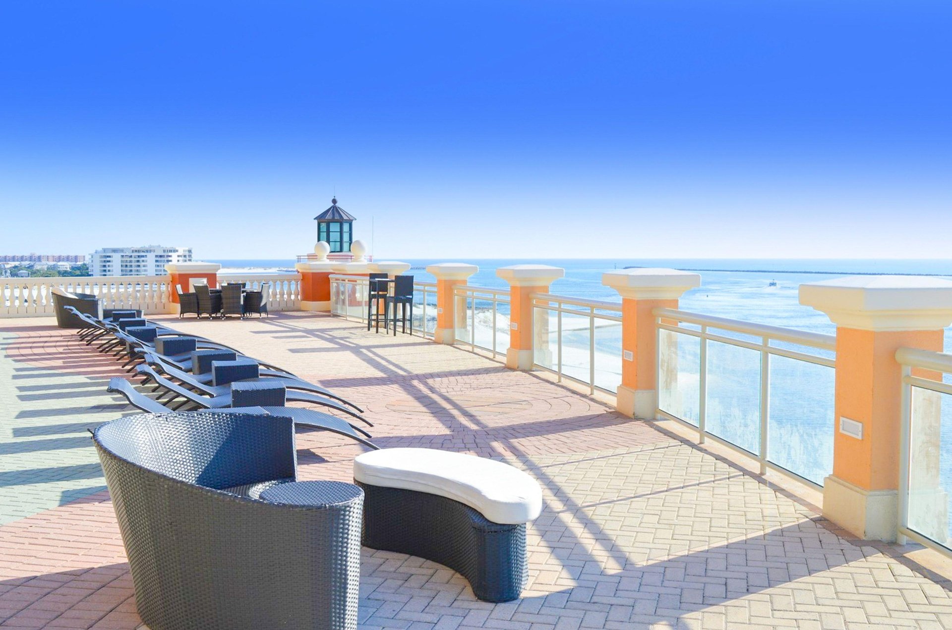 An Emerald Grande sundeck and loungers looking out over the water.