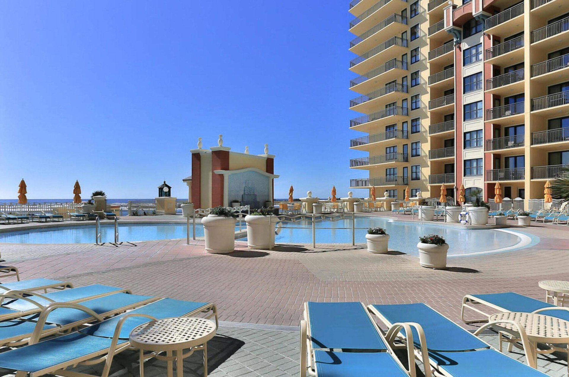 A view of a complex swimming pool surrounded by loungers.