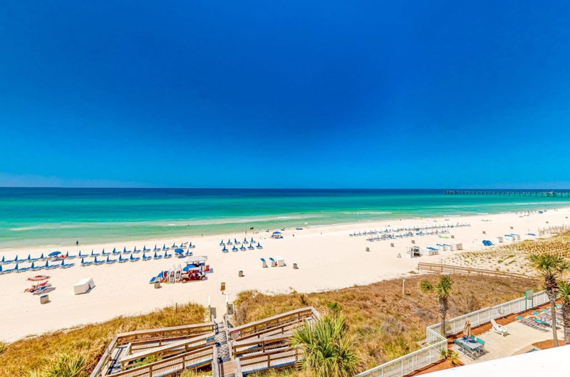 Lounge chairs next to a glass door on a private balcony at Aqua Resort