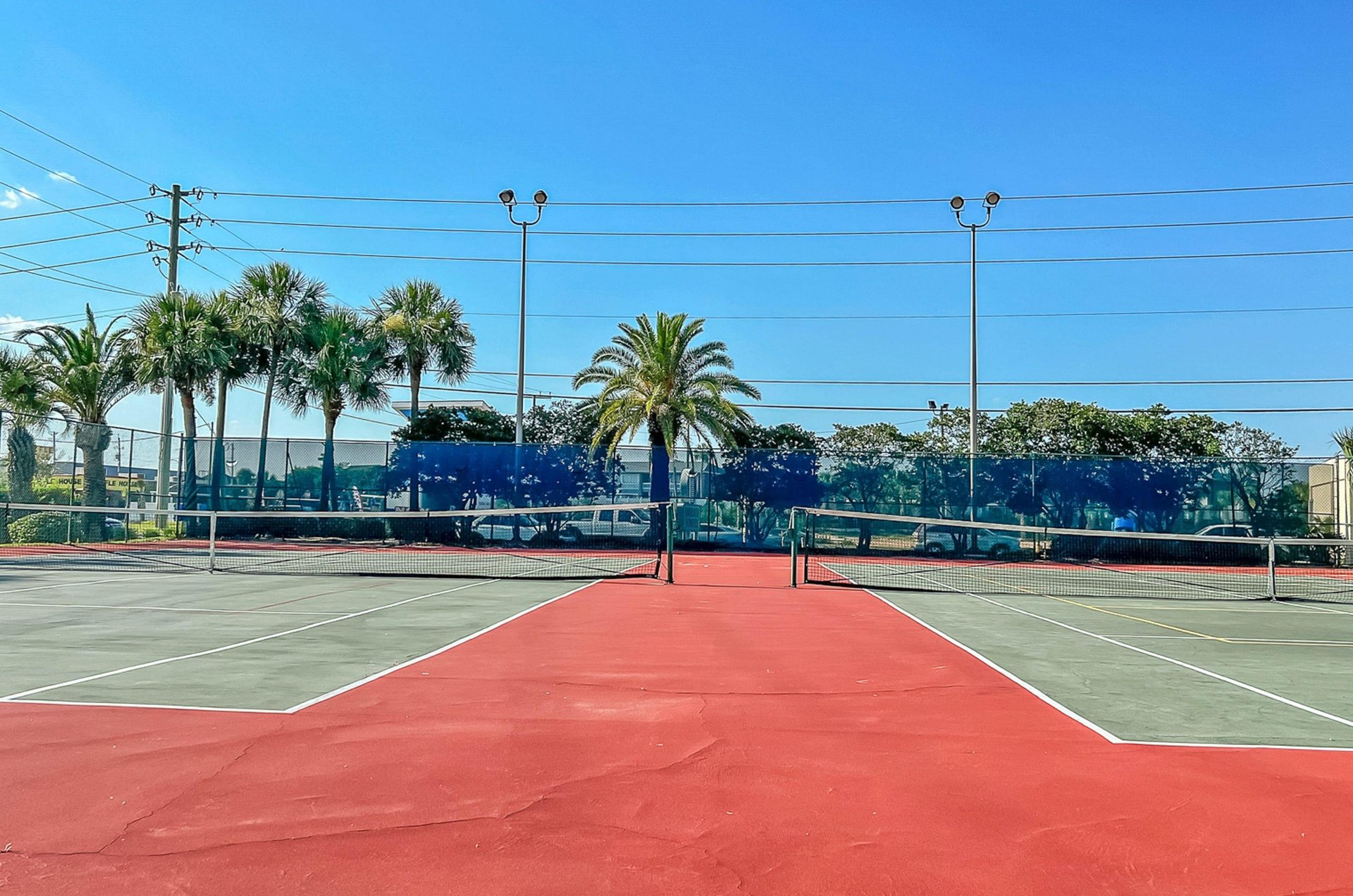 The complex has lighted tennis courts for playing day and night.