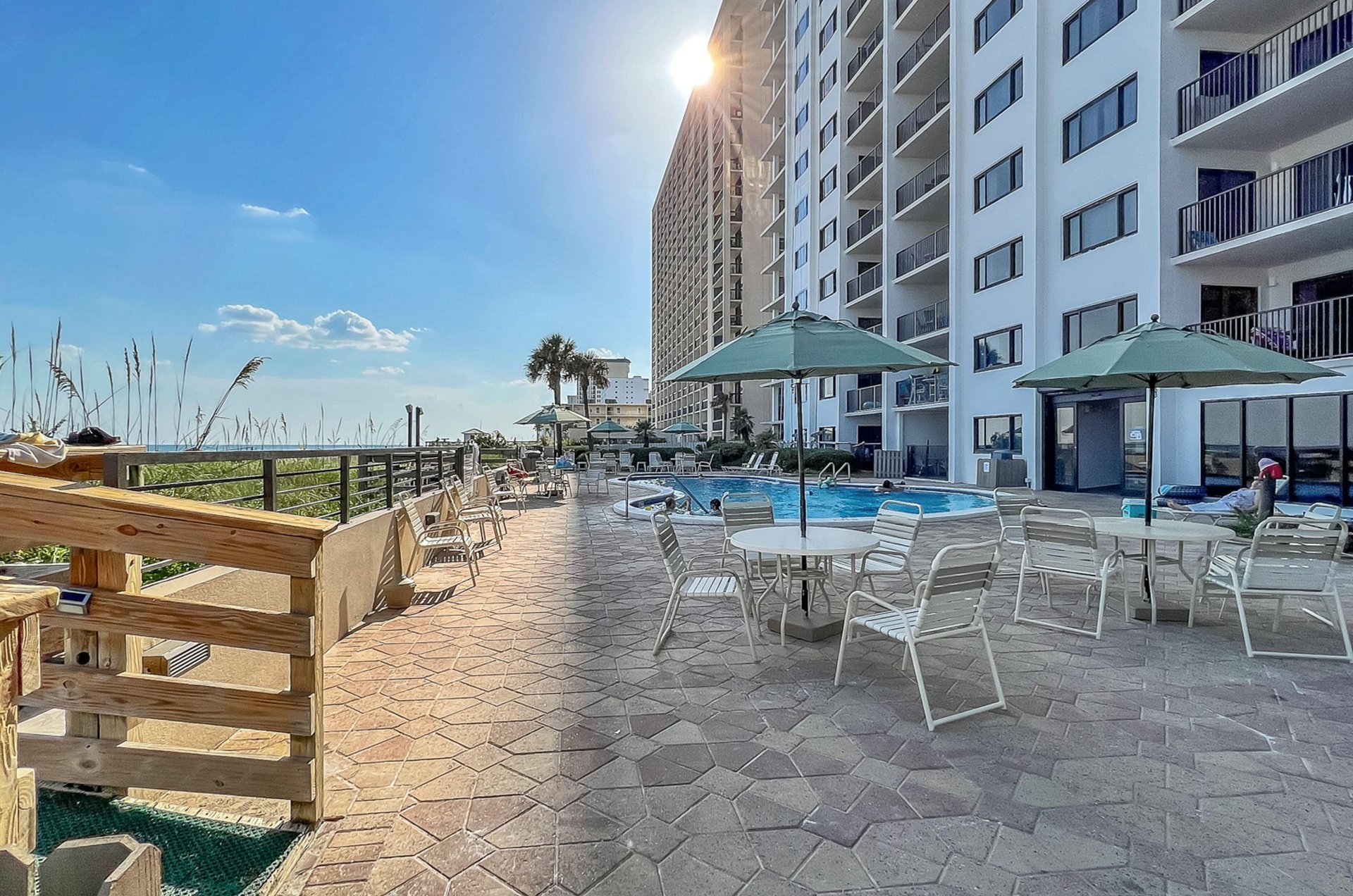 The swimming pool sits beachside and is surrounded by a spacious sundeck with ample seating.