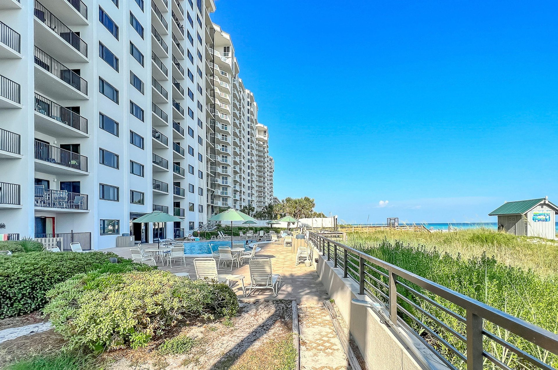 Unit balconies provide sweeping views of the swimming pool and beaches beyond.
