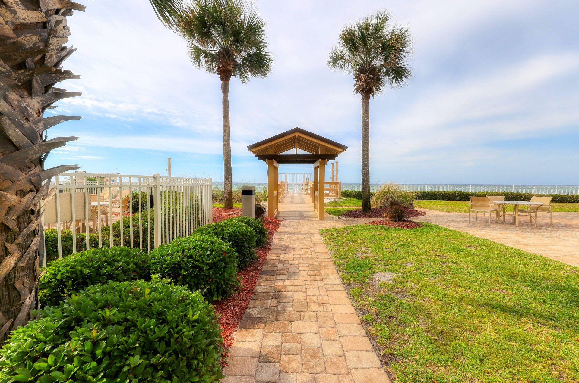 A boardwalk and gated entrance to the private beach