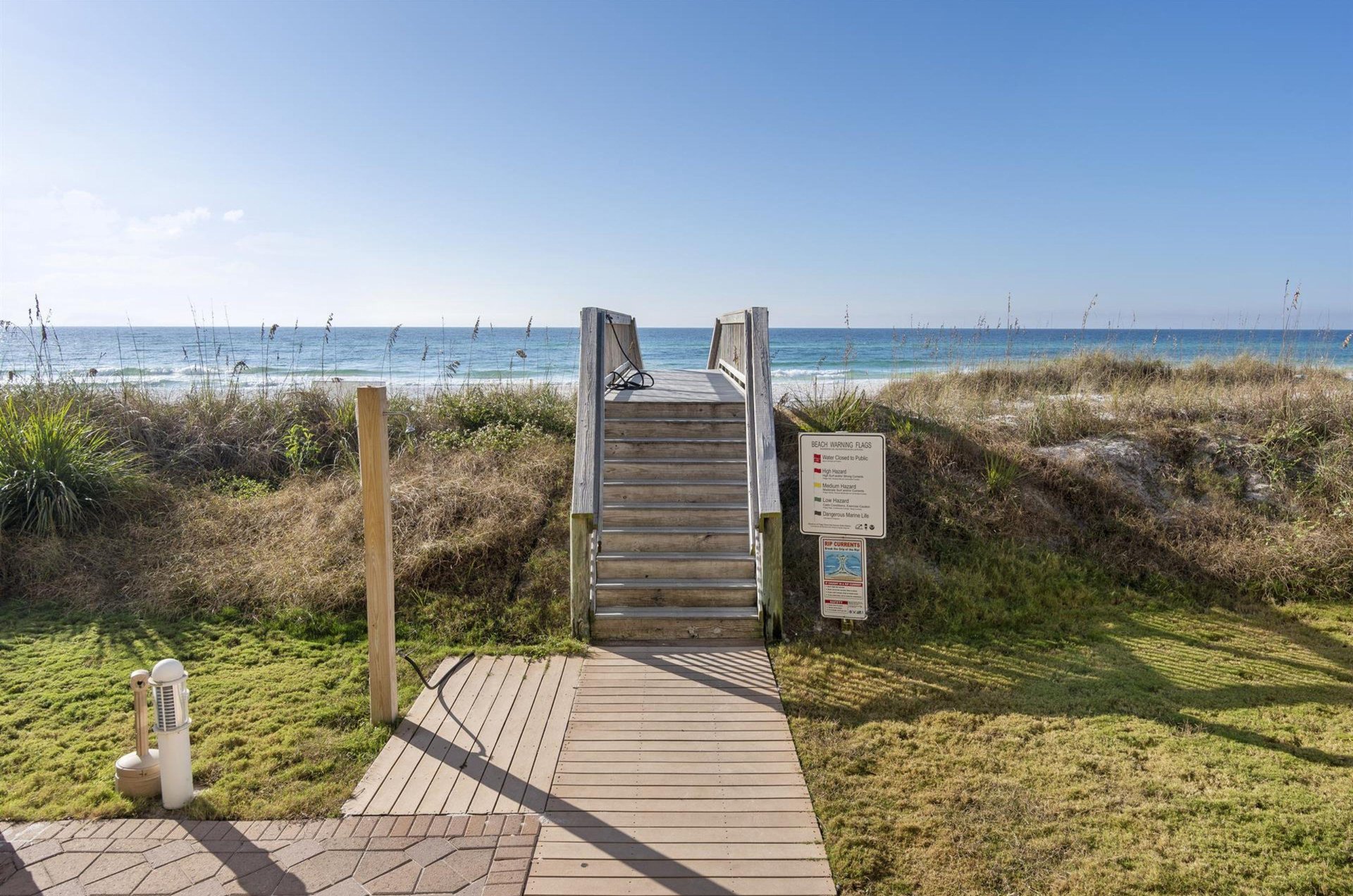 The boardwalk leading to and from the beach provides a shower and hose for rinsing off salt and sand.