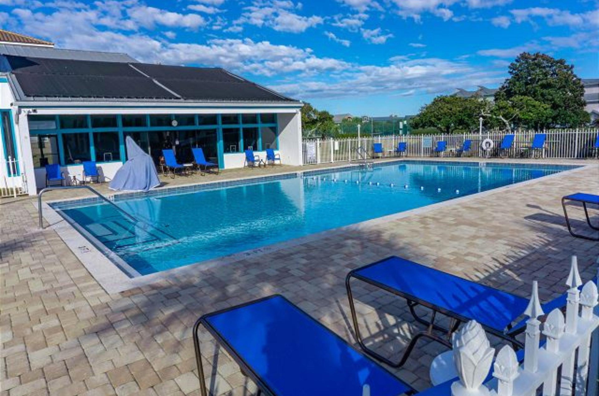 The pool has a large sundeck and cabana providing shade.