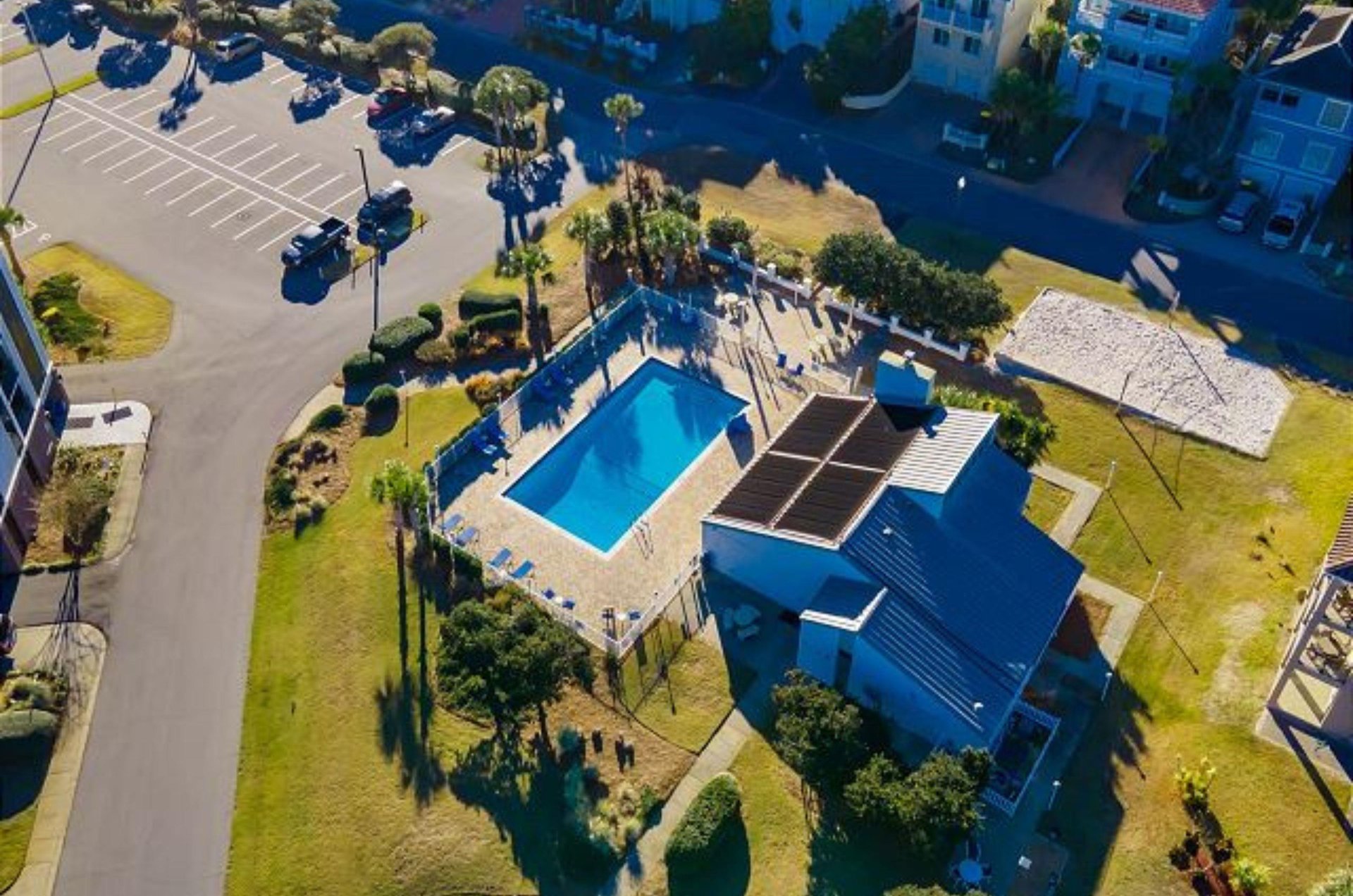 And aerial view of the complex swimming pool, cabana, and parking lot.