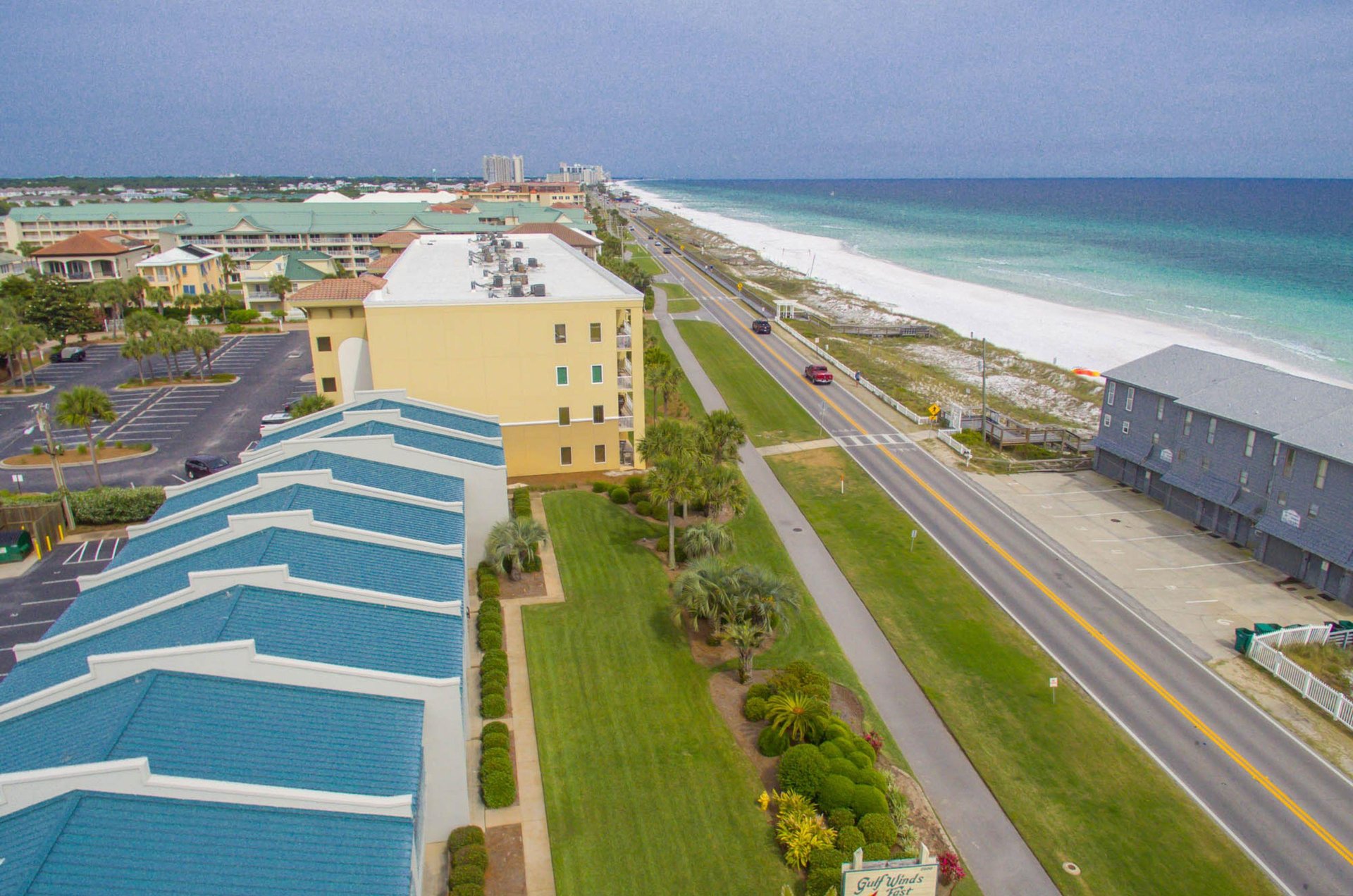The complex with the blue roof is a short stroll across a twolane road from the beach.