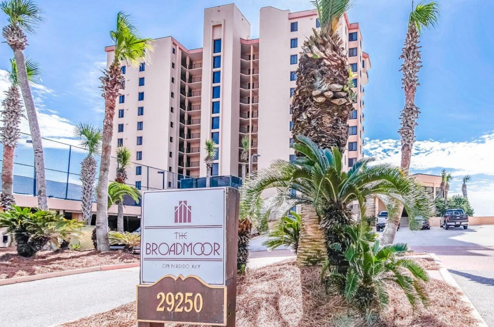 The streetside exterior of Broadmoor Codominiums and the propertys entry sign