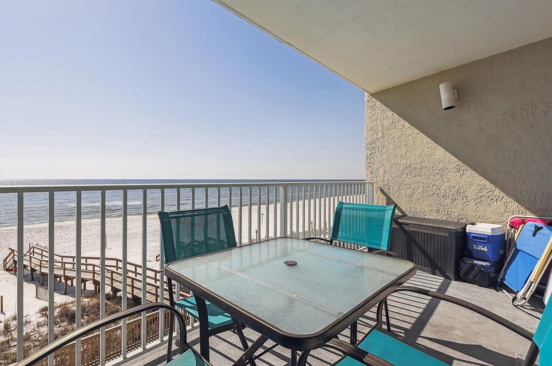 A private balcony at Perdido Skye with a table and chairs overlooking the Gulf of Mexico