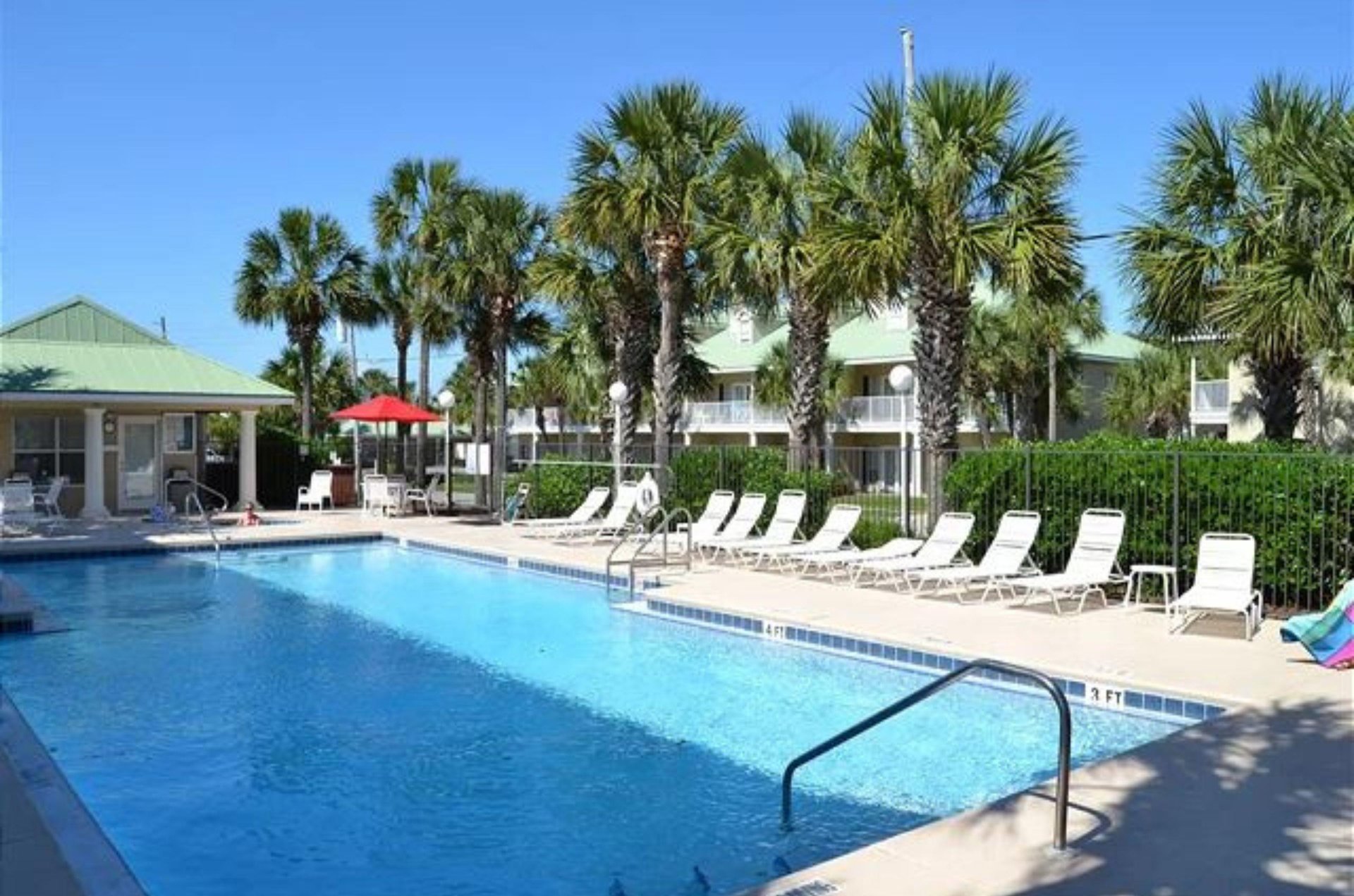 Caribbean Dunes swimming pool, sundeck, and lounge chairs.