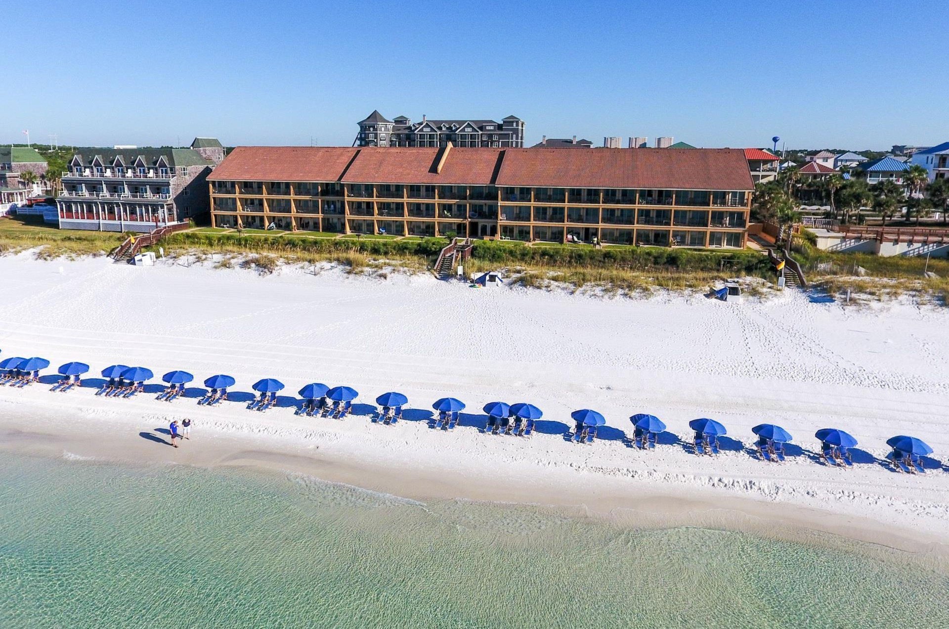 Coral Reef Clubs beach set up with beach chairs and umbrellas.