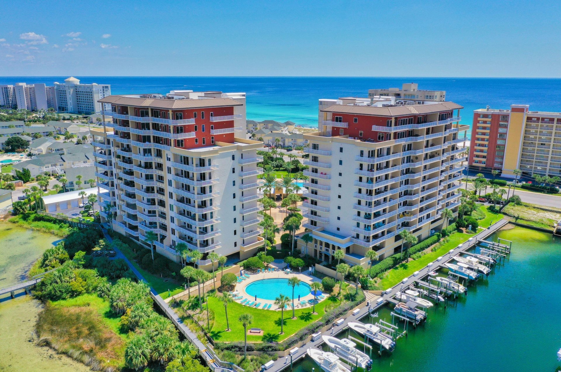 Aerial view of the two towers with a circular owners pool next to the harbor