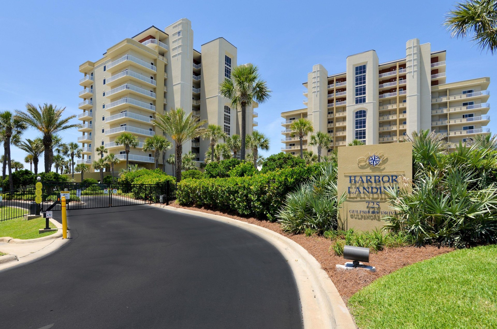 Street view of Harbor Landing in Destin Florida with the propertys sign and entry road