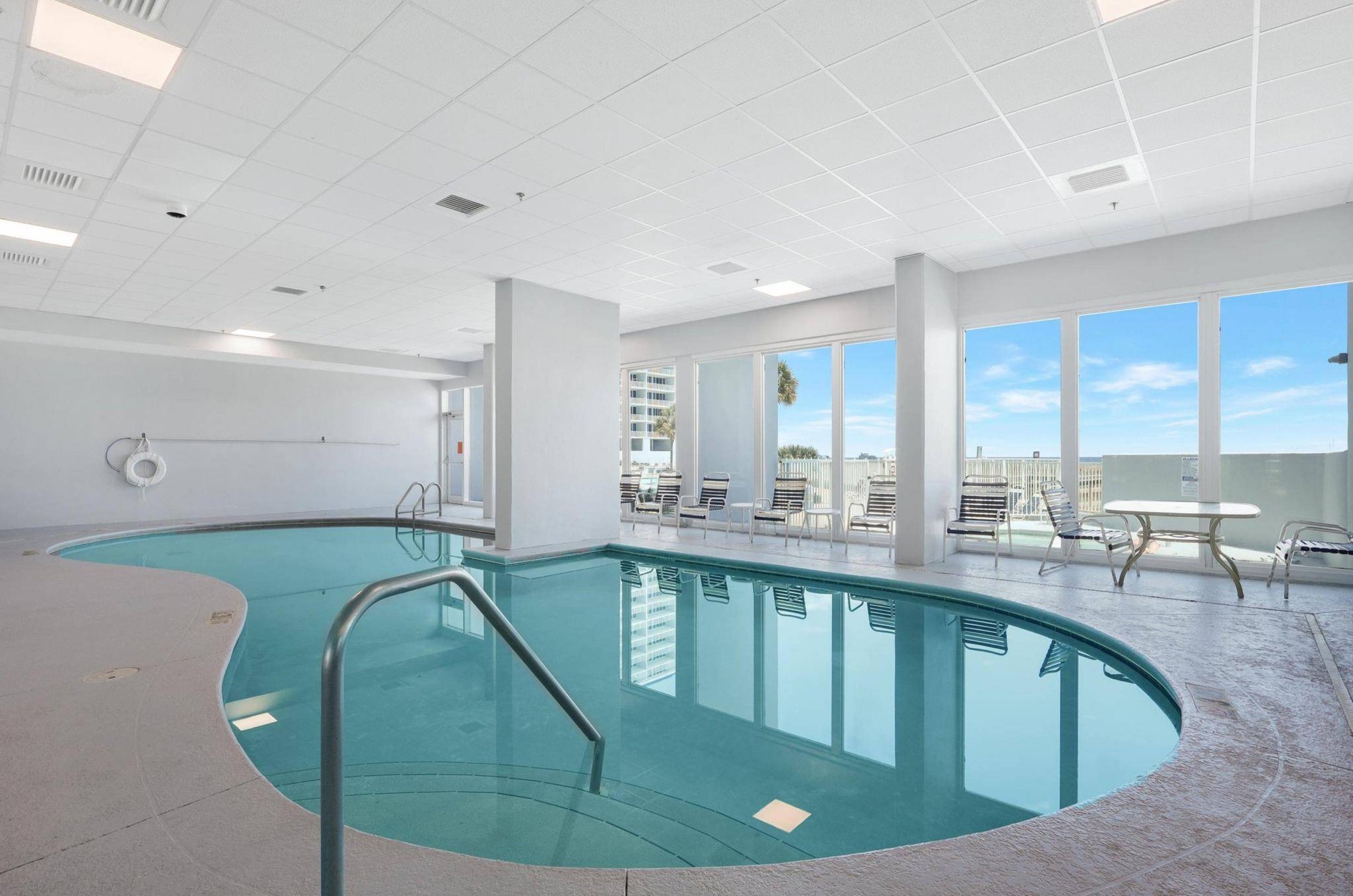 The indoor pool next to floor to ceiling windows overlooking the Gulf