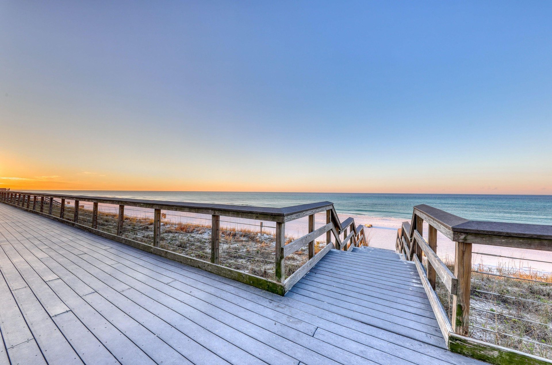Boardwalk leading to a sunrise over the beach
