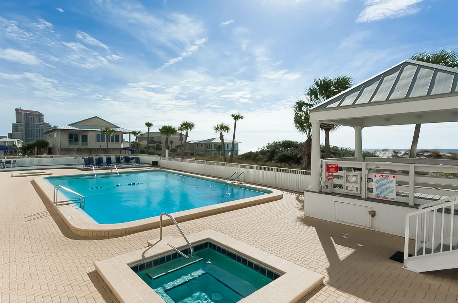 The fencedin pool and hot tub.