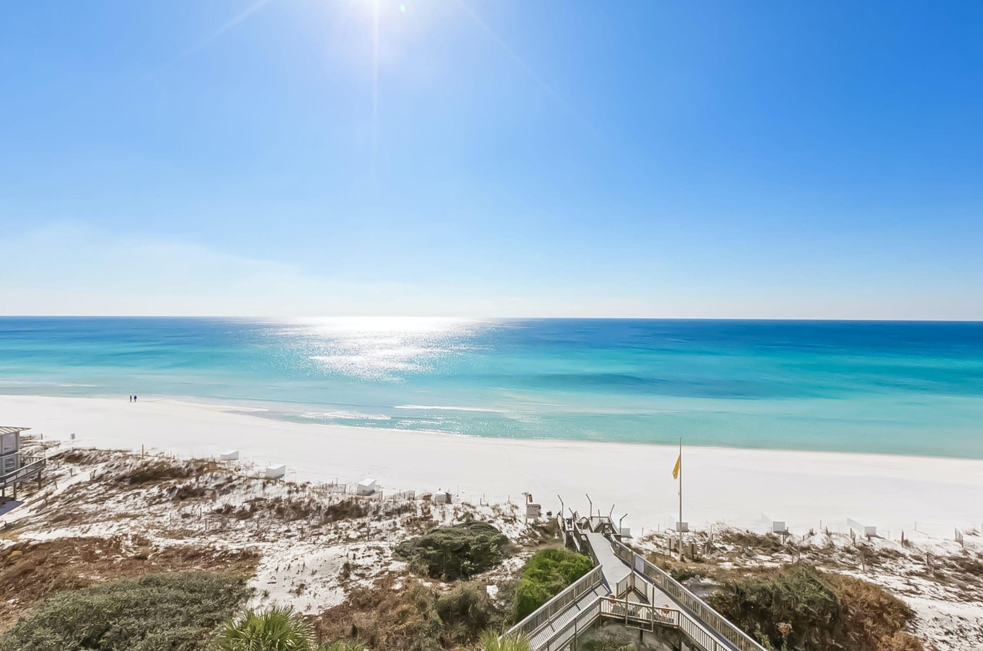 The sun shining down on the snowwhite and turquoise coast alongside Hidden Dunes.