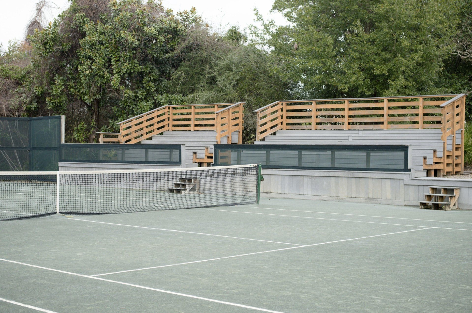 A Hidden Dunes tennis court with ample seating for viewers.