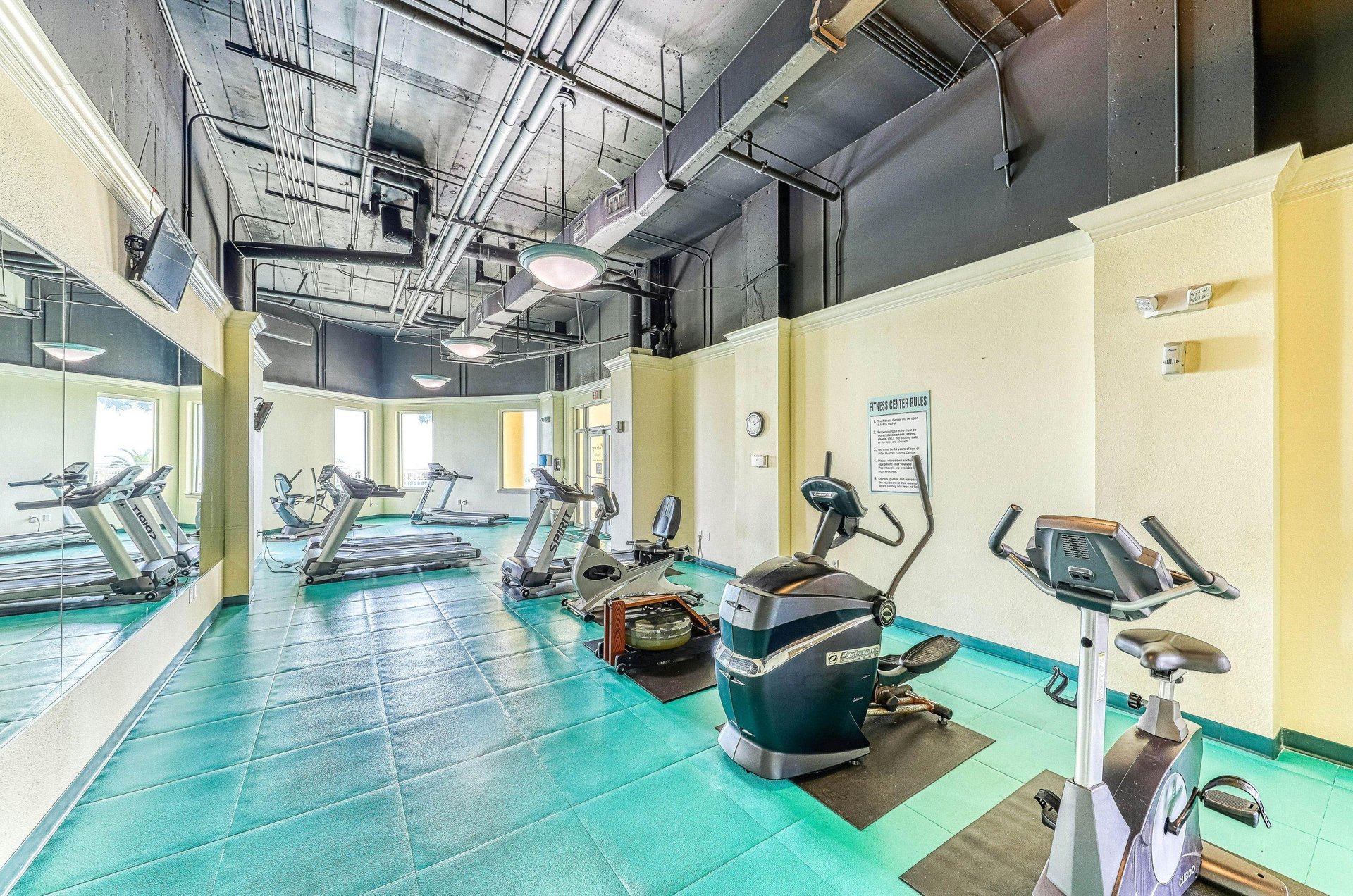 Cardio equipment and floortoceiling mirrors in the resorts fitness center