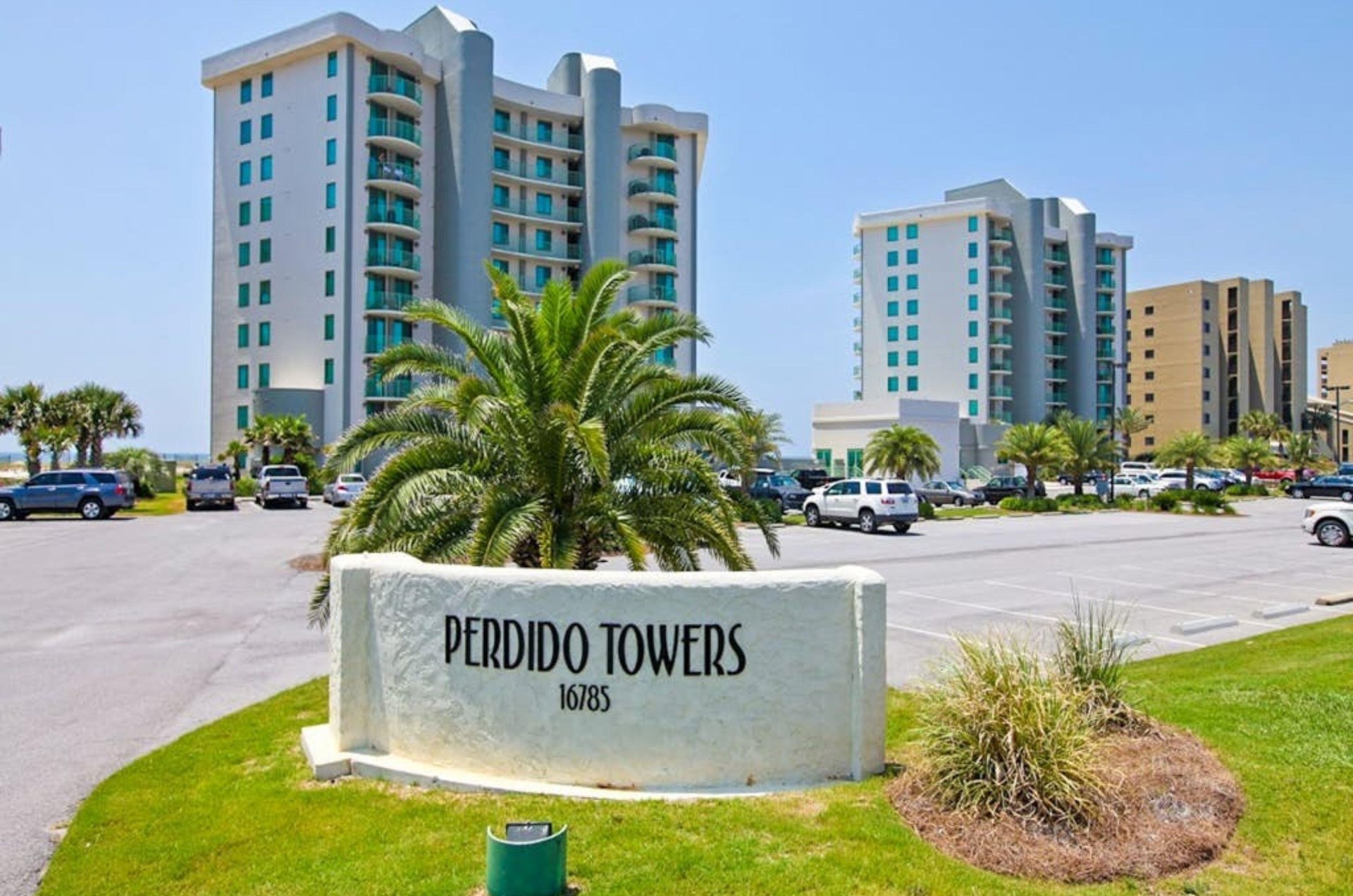 View from the street of Perdido Towers and the parking lot in front of the property