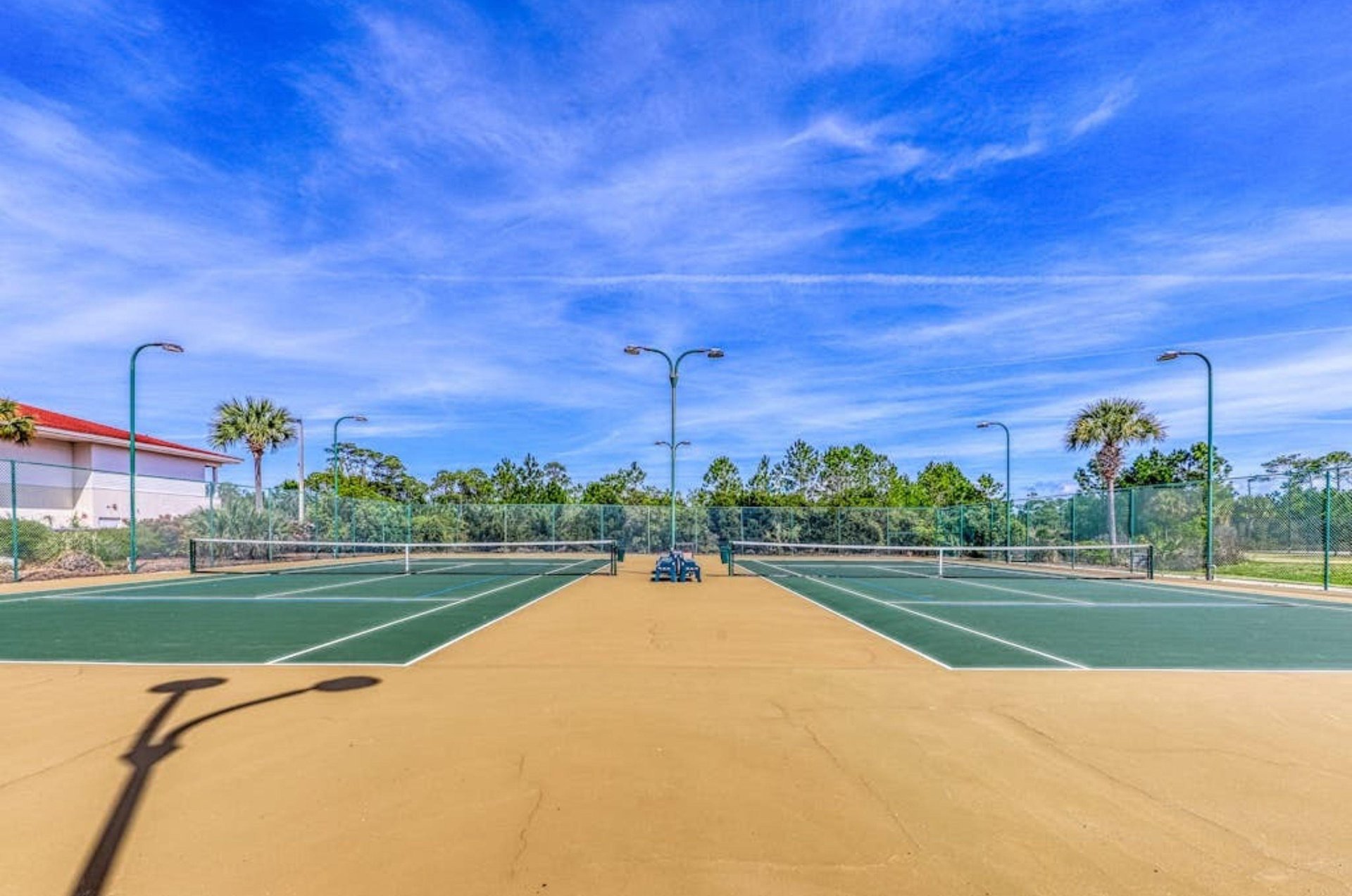 The lighted outdoor tennis courts at Palacio Condos