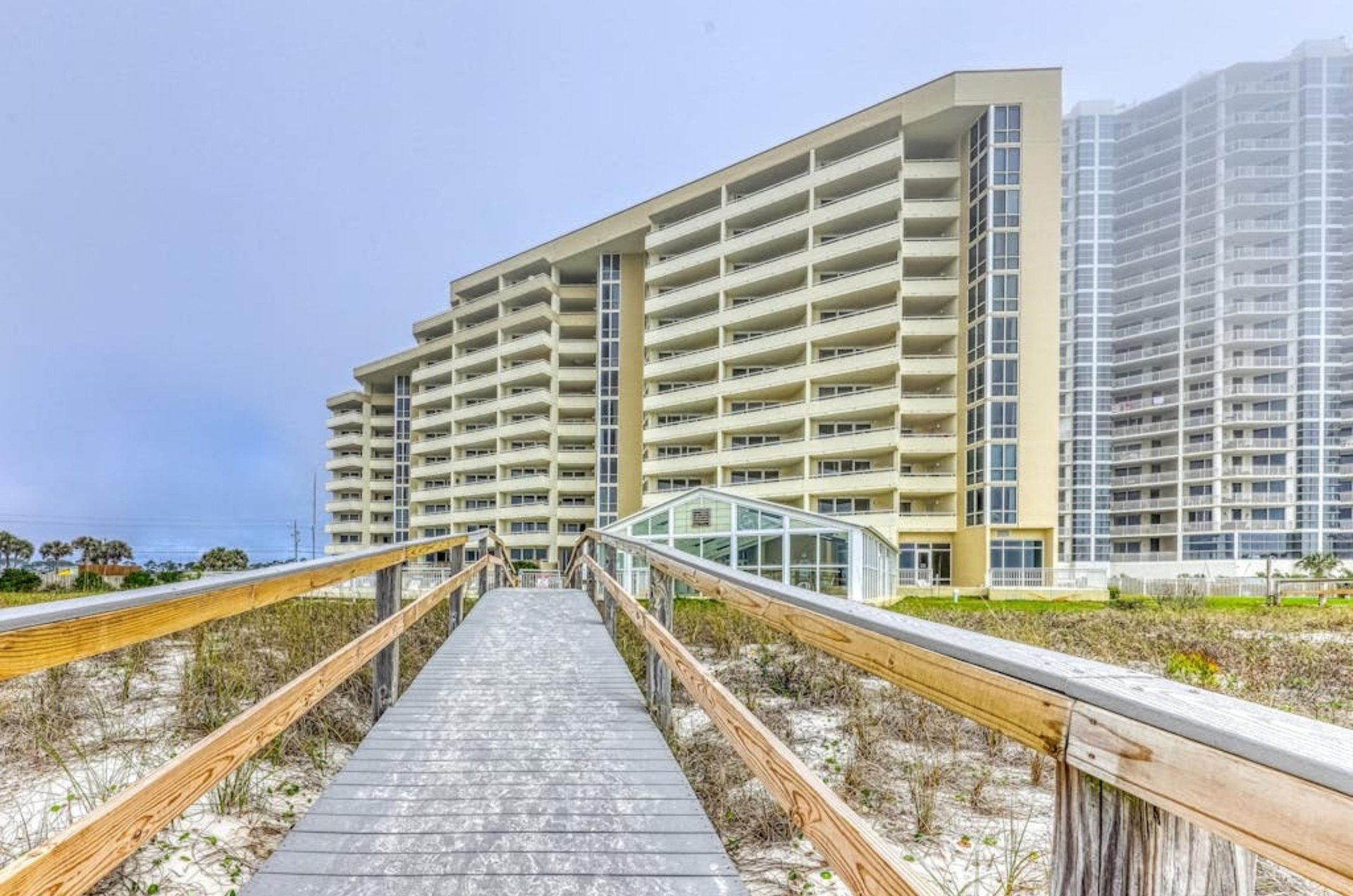 Boardwalk in front of the beachfront facade of Perdido Sun in Perdido Key Florida