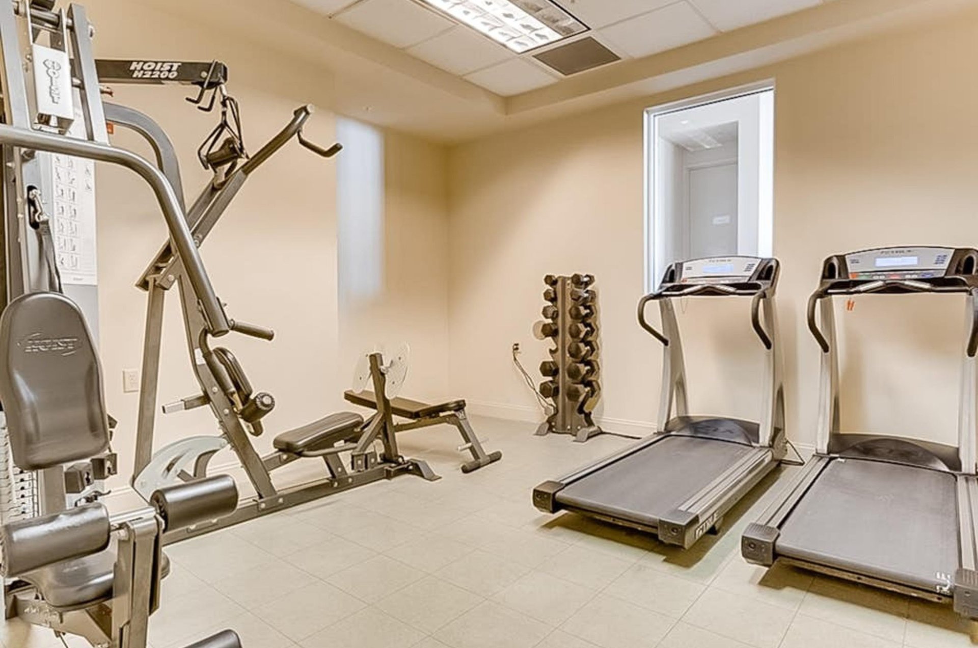 The onsite fitness center with treadmills and strength equipment at Perdido Sun in Perdido Key Florida