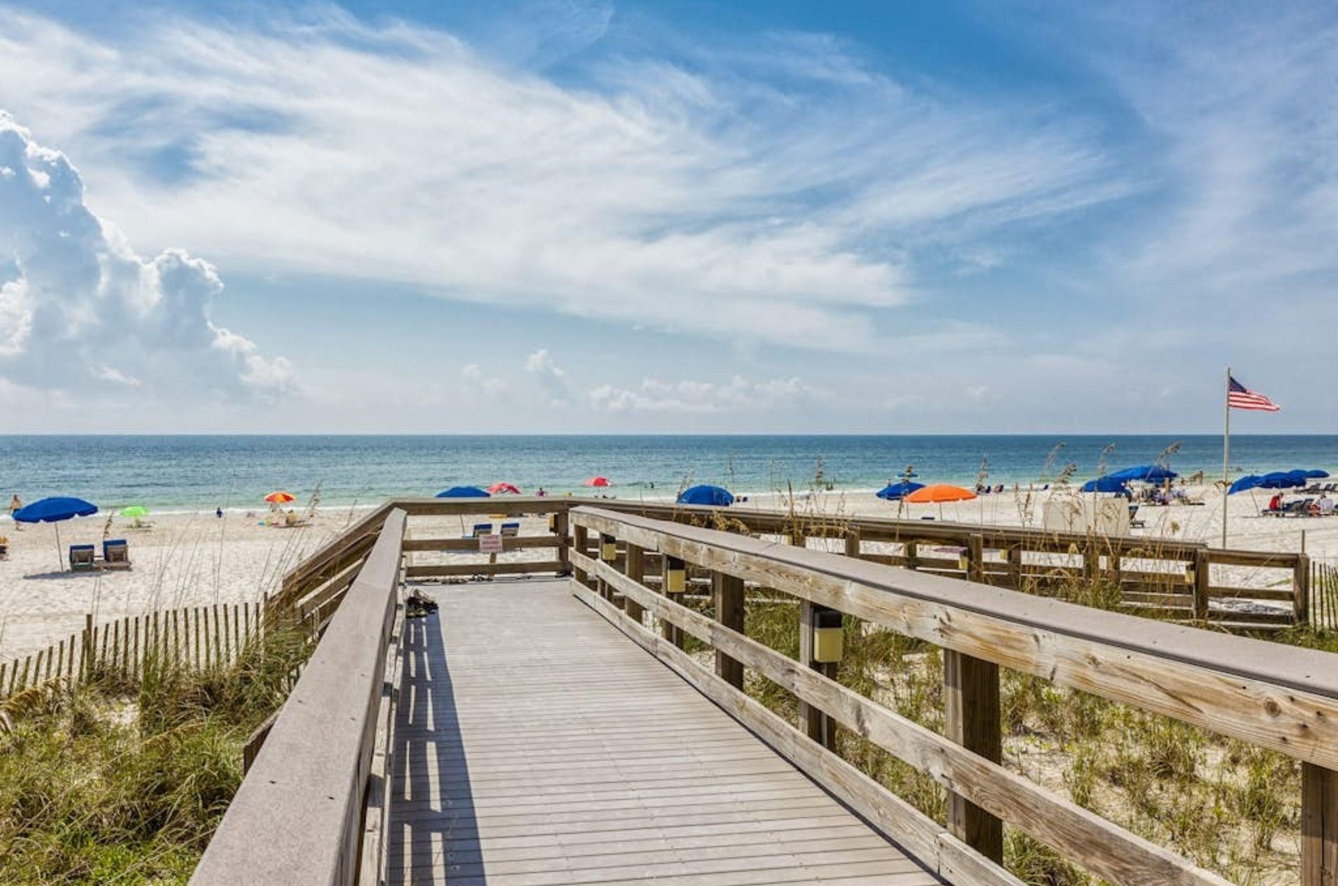A wooden boardwalk leading to the Gulf at Pelican Pointe