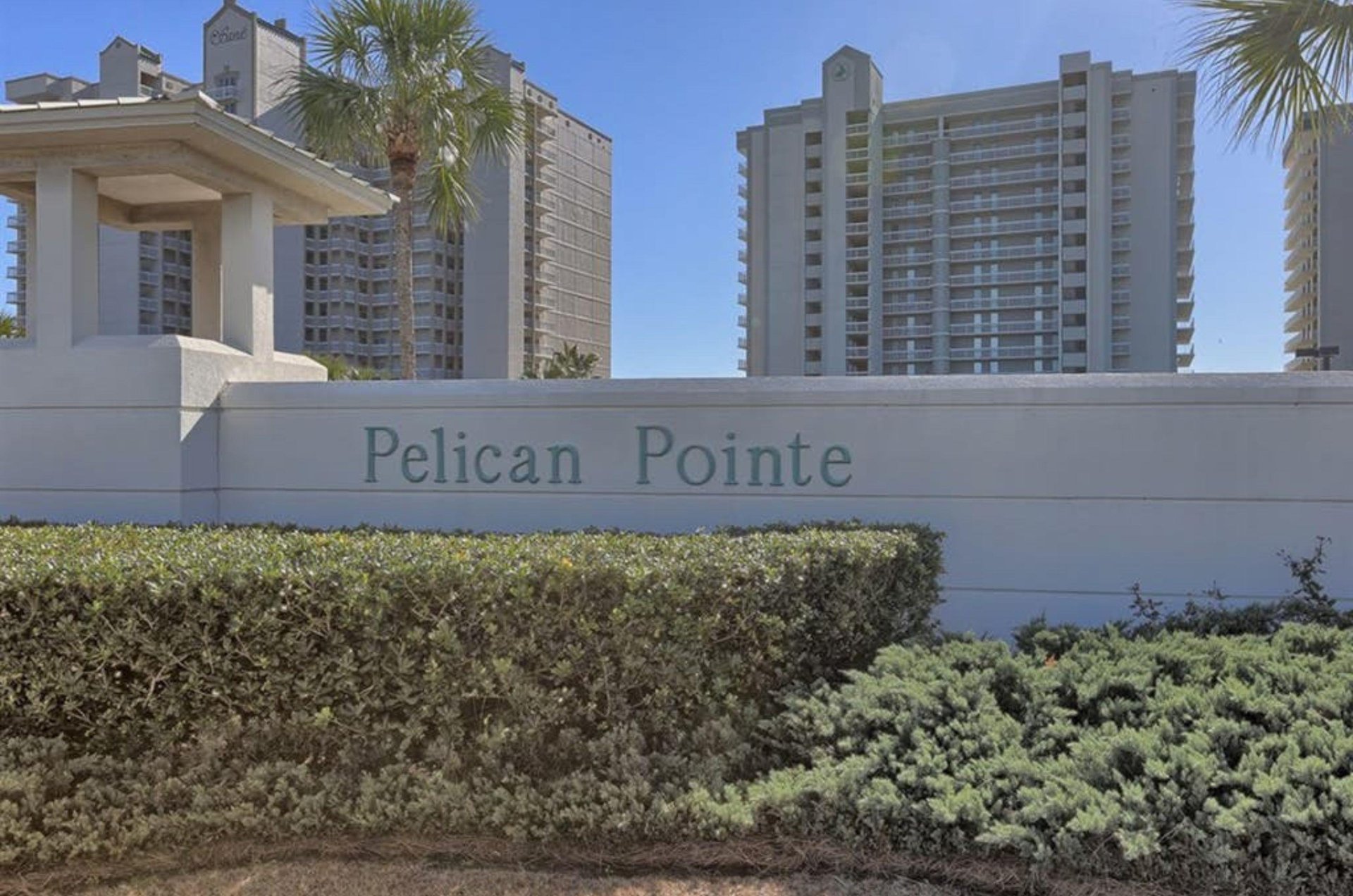View from the street of Pelican Pointe Condominiums and the propertys entry sign