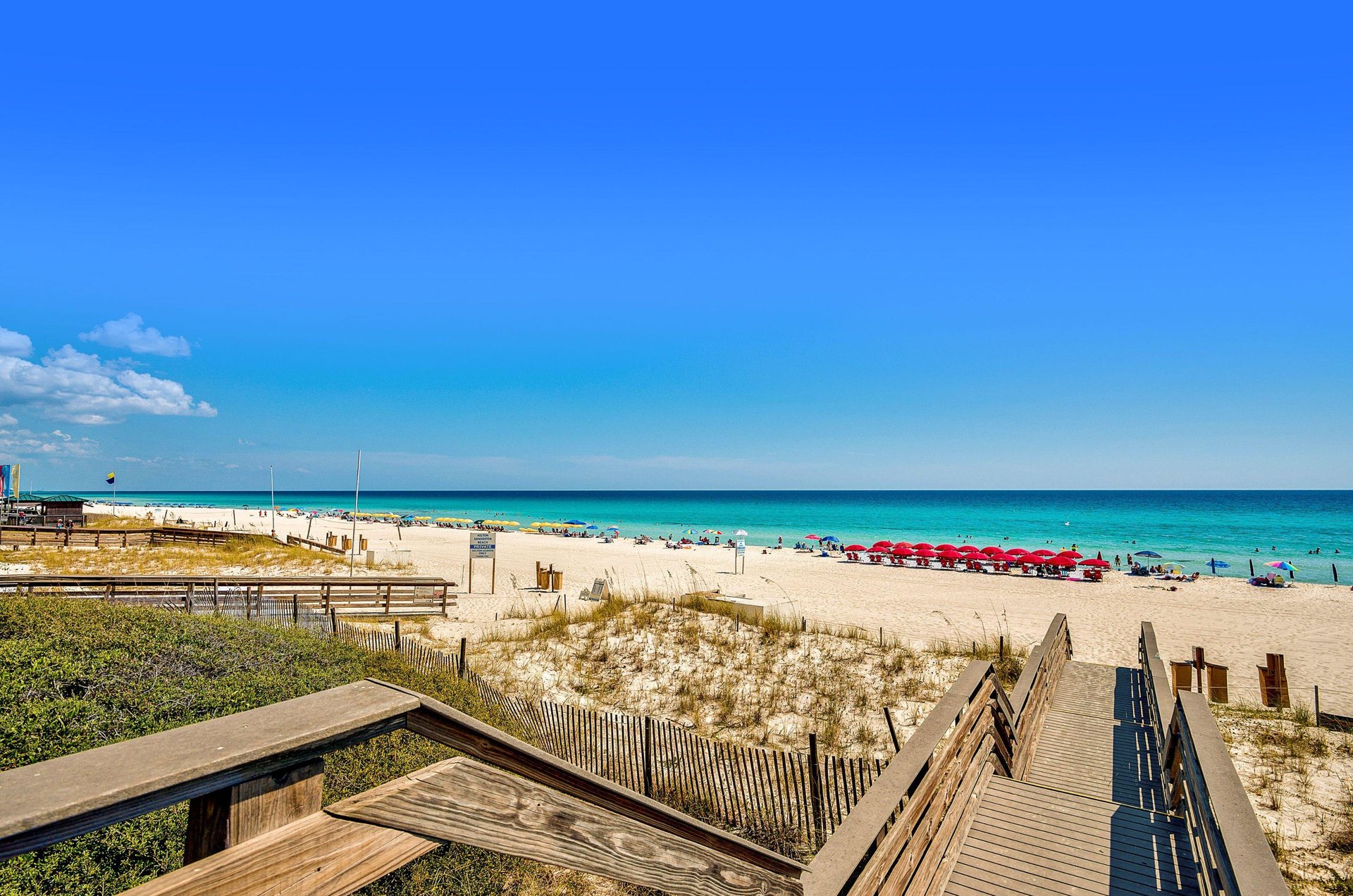 A convenient boardwalk leads to this beautiful turquoiseandaqua coastline where dozens of beach chairs and umbrellas provide relaxing respite from the sun