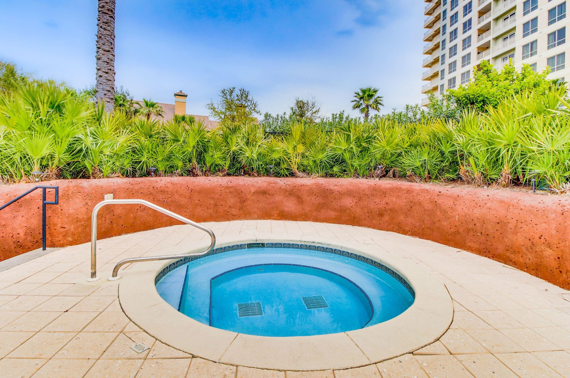 A crystalclear hot tub with tropical landscaping provides a private place for relaxing