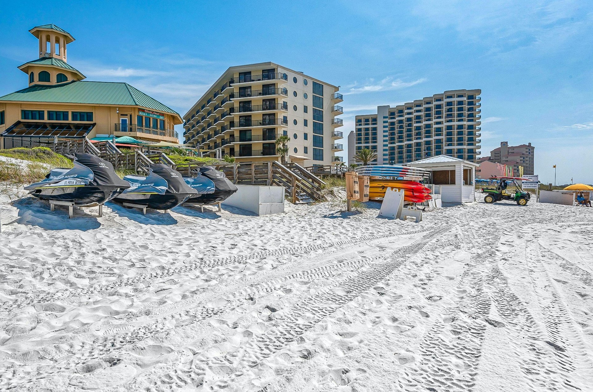 Waverunners, paddleboards, kayaks and other watersports equipment stands ready for resort guests to rent.