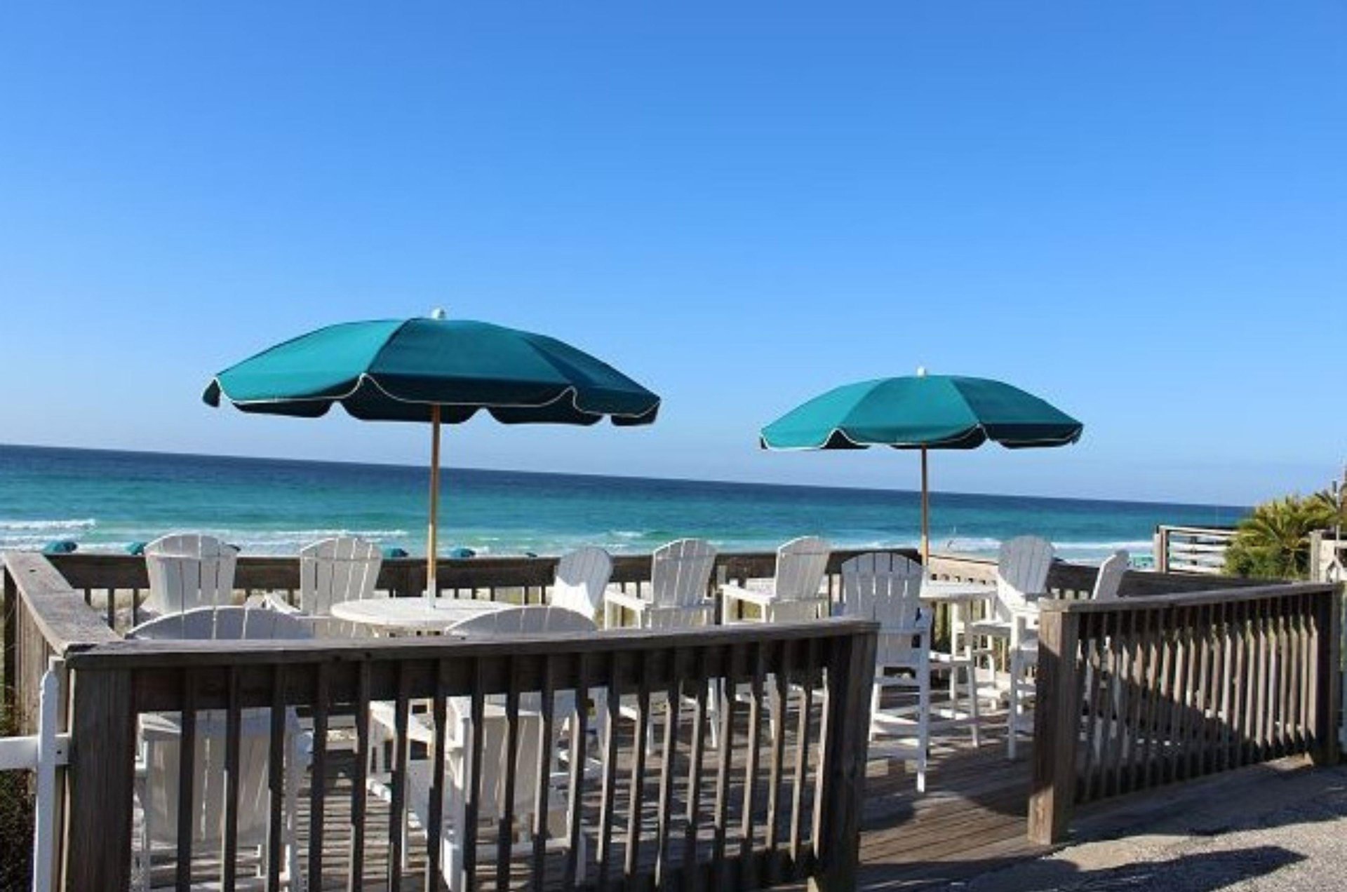 Adirondack chairs provide great views of the beautiful beach.