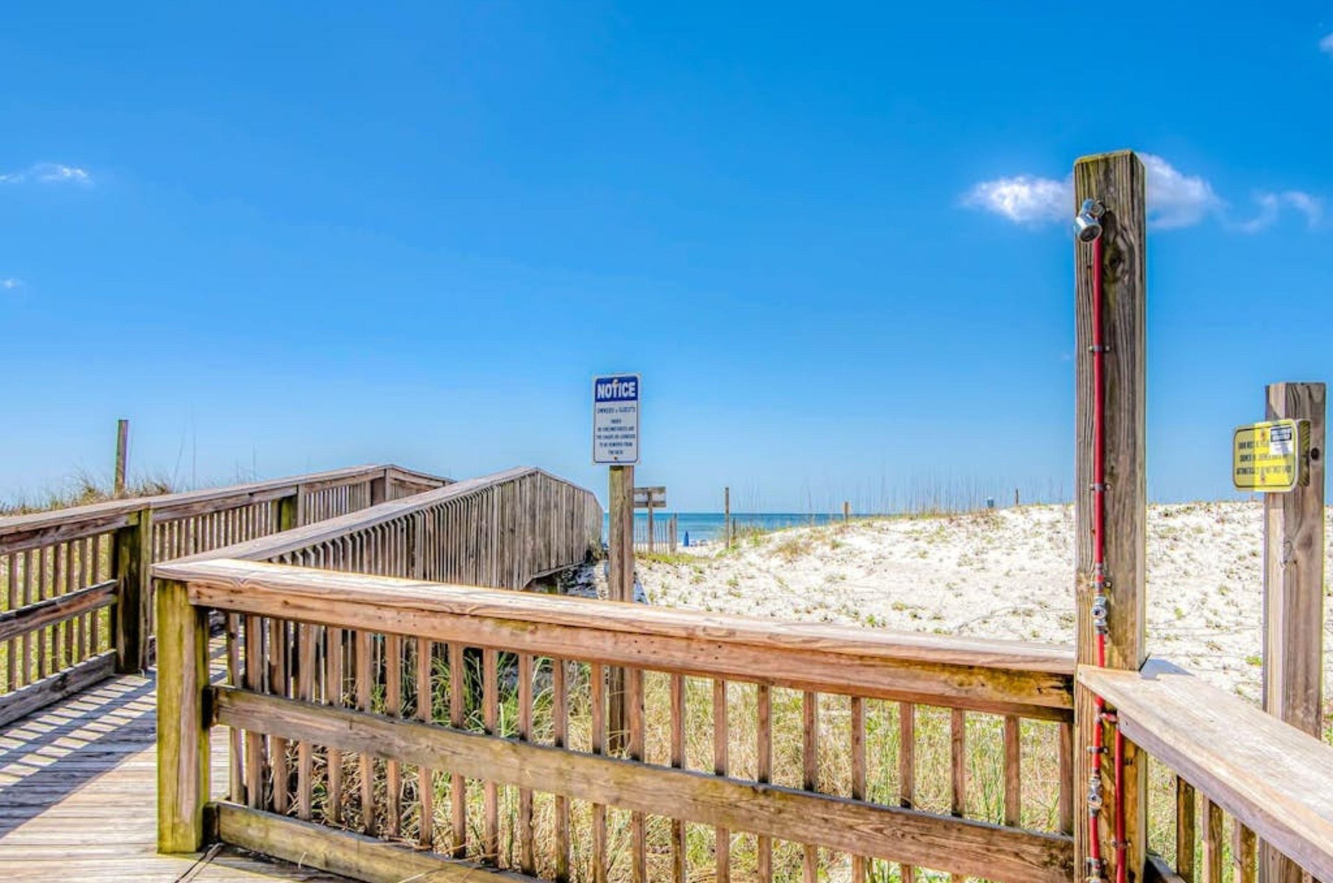 The outdoor showers on the wooden boardwalk at Island Sunrise in Gulf Shores Alabama