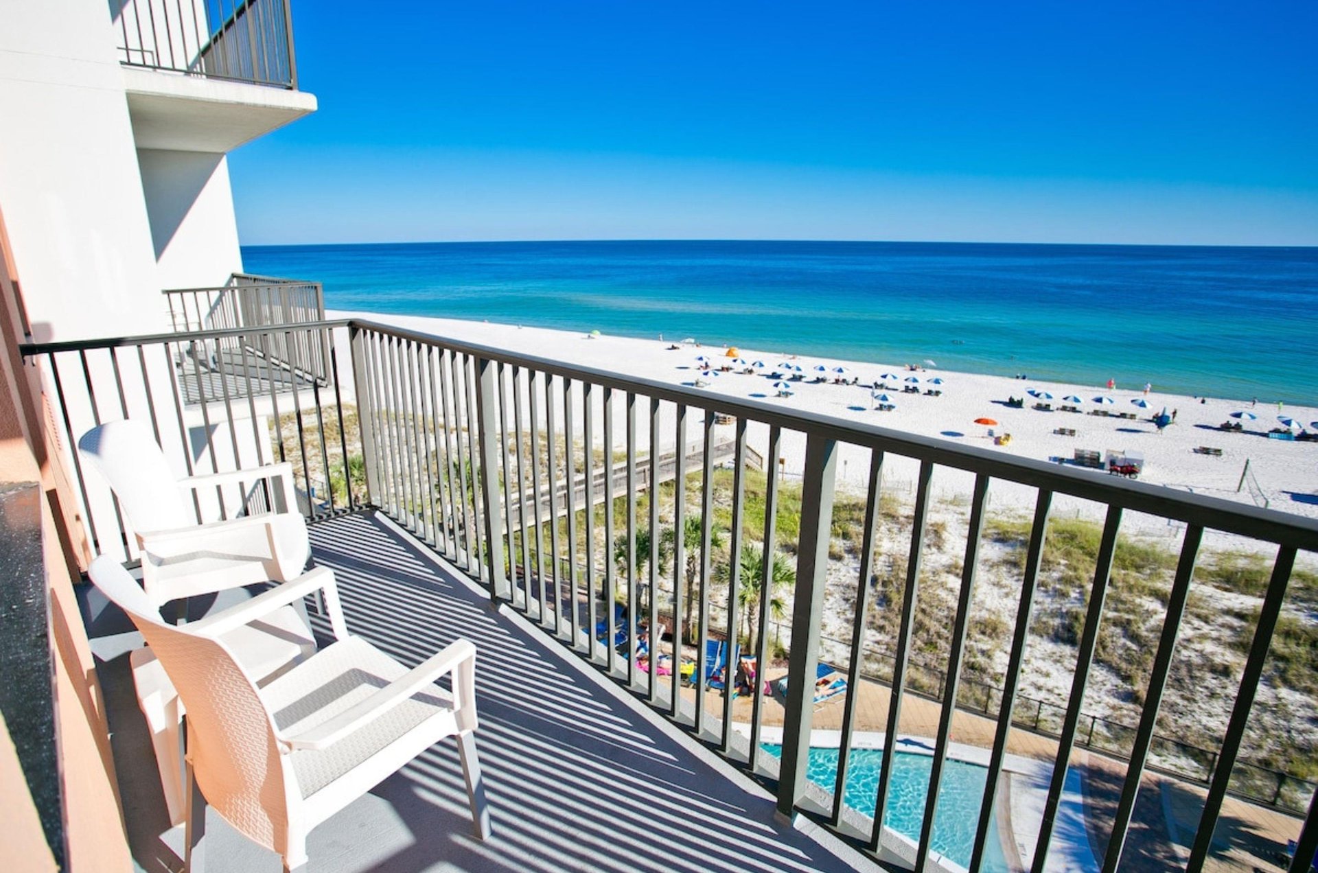 Private balcony with lounge chairs overlooking Orange Beach and the Gulf of Mexico