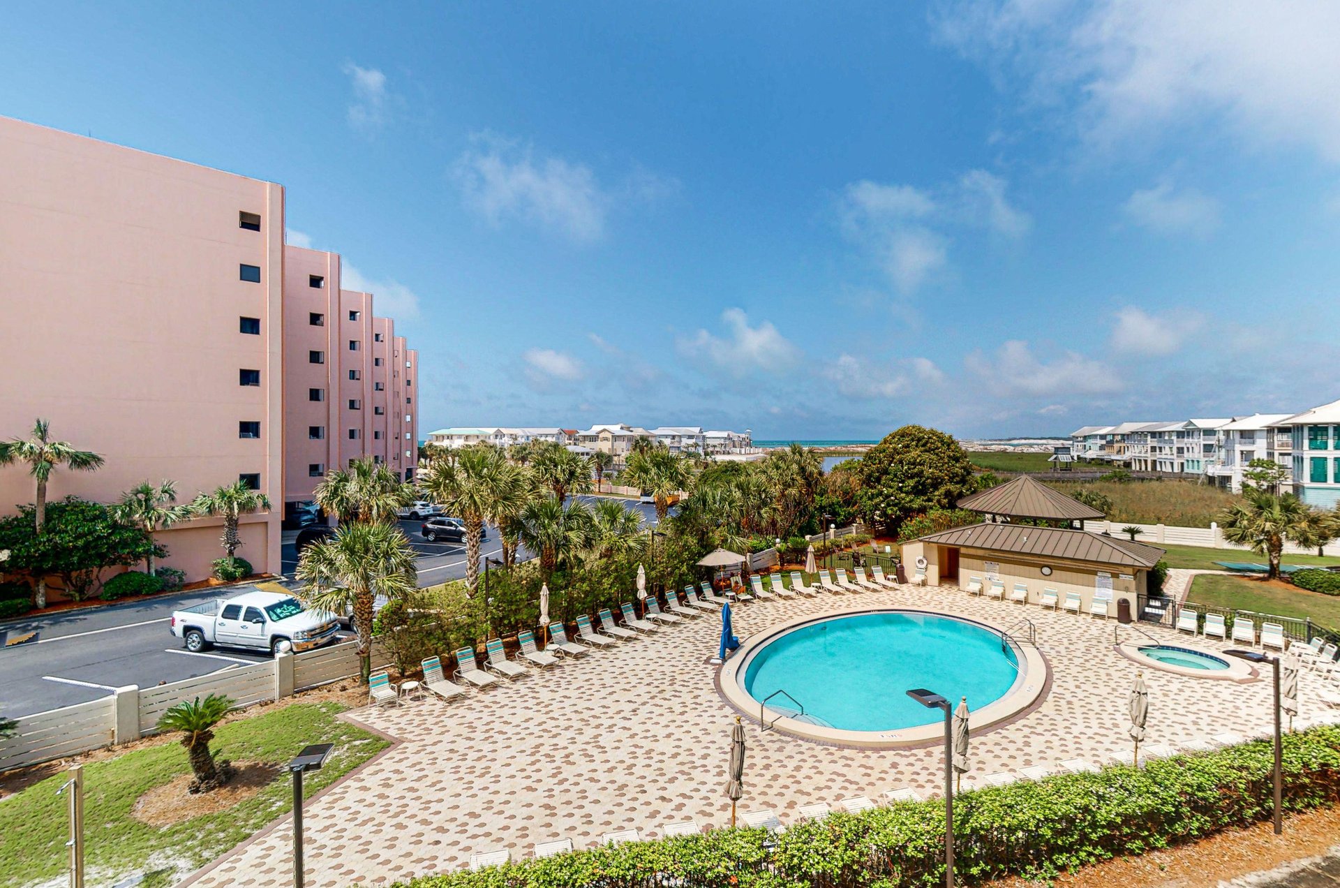 A community pool and sundeck lined with loungers