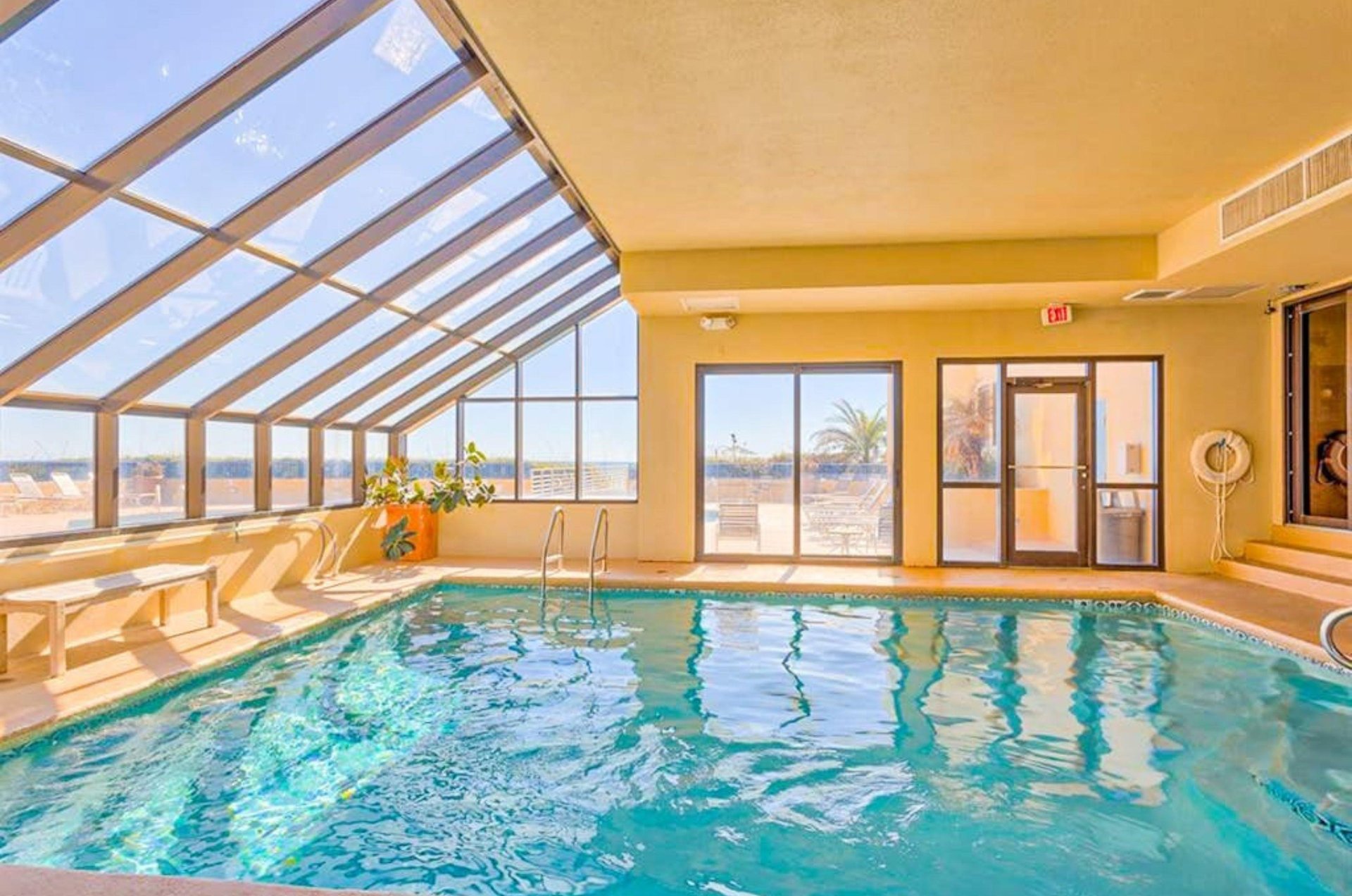The indoor swimming pool next to windows at Four Seasons in Orange Beach Alabama