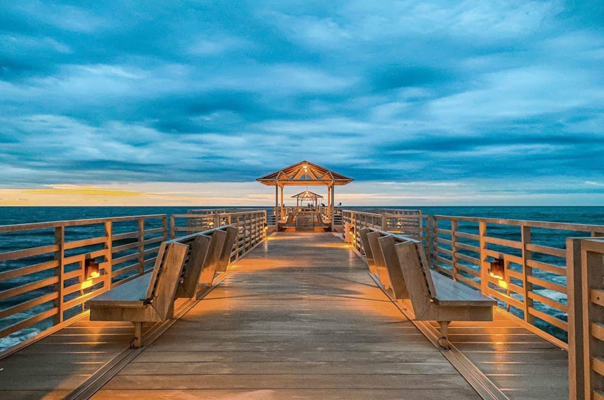 The fishing pier lit up at night in front of Four Seasons in Orange Beach Alabama
