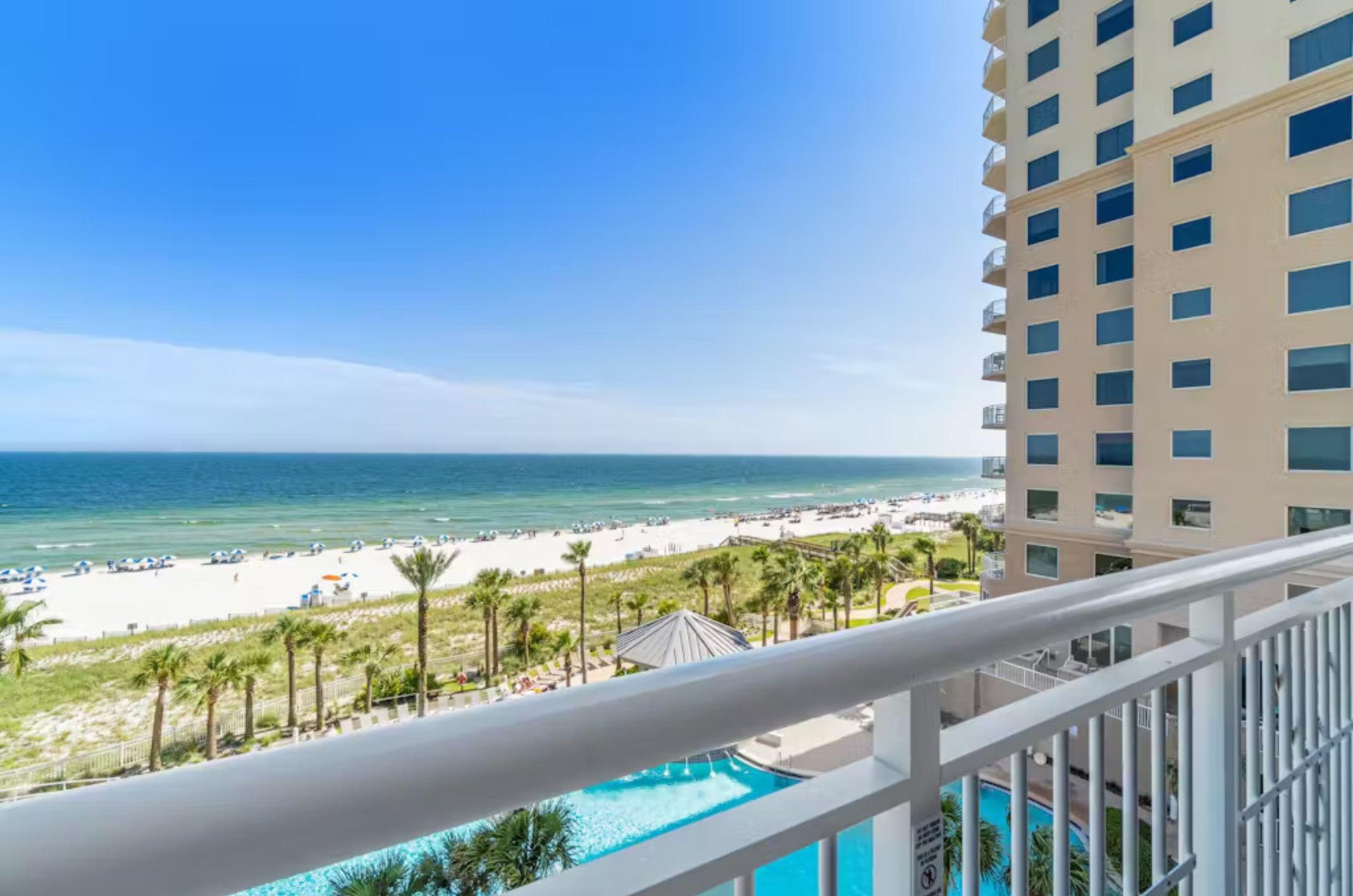 View of the outdoor pool and Gulf of Mexico from a private balcony